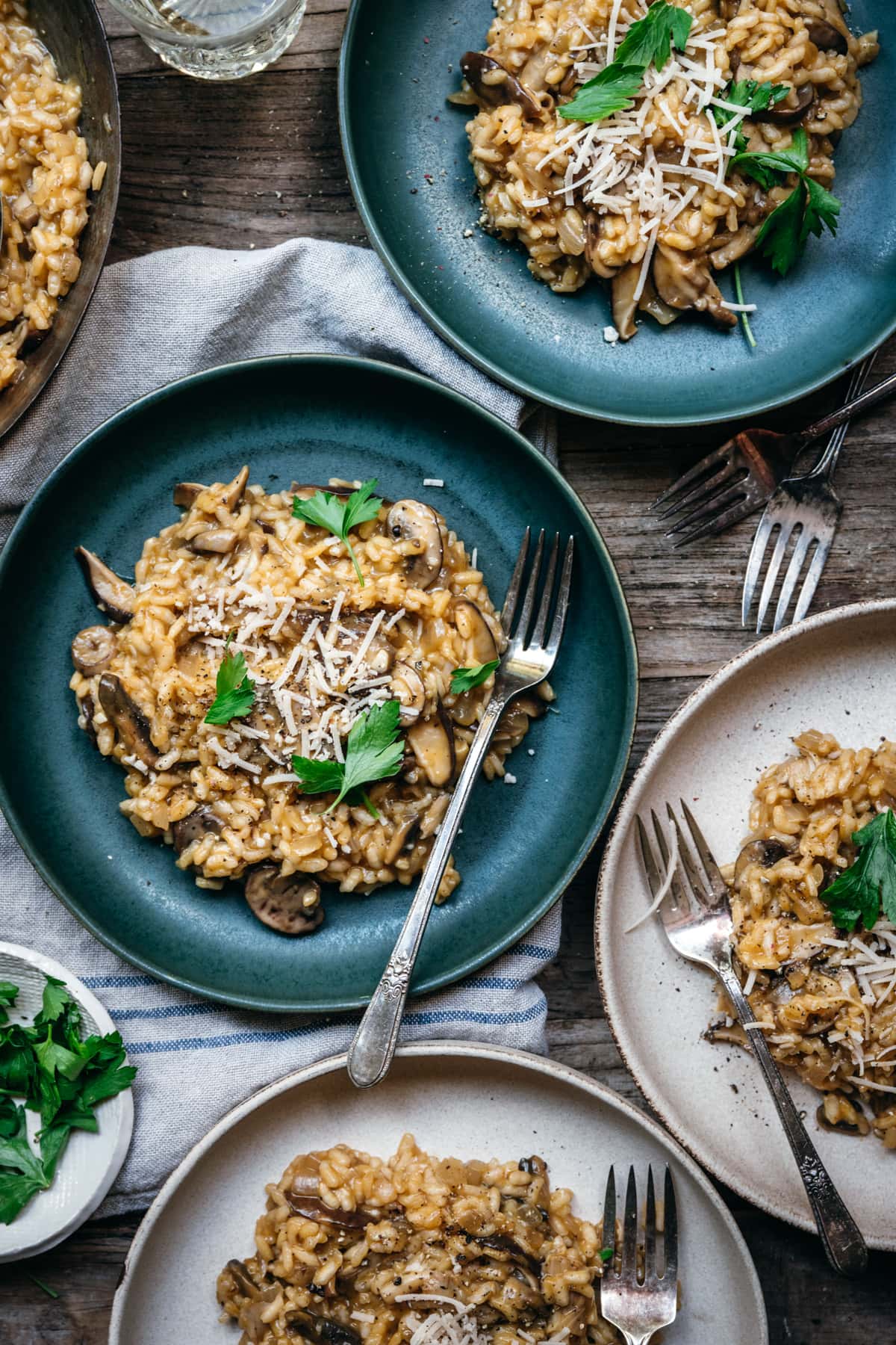 overhead view of multiple bowls of vegan mushroom risotto.