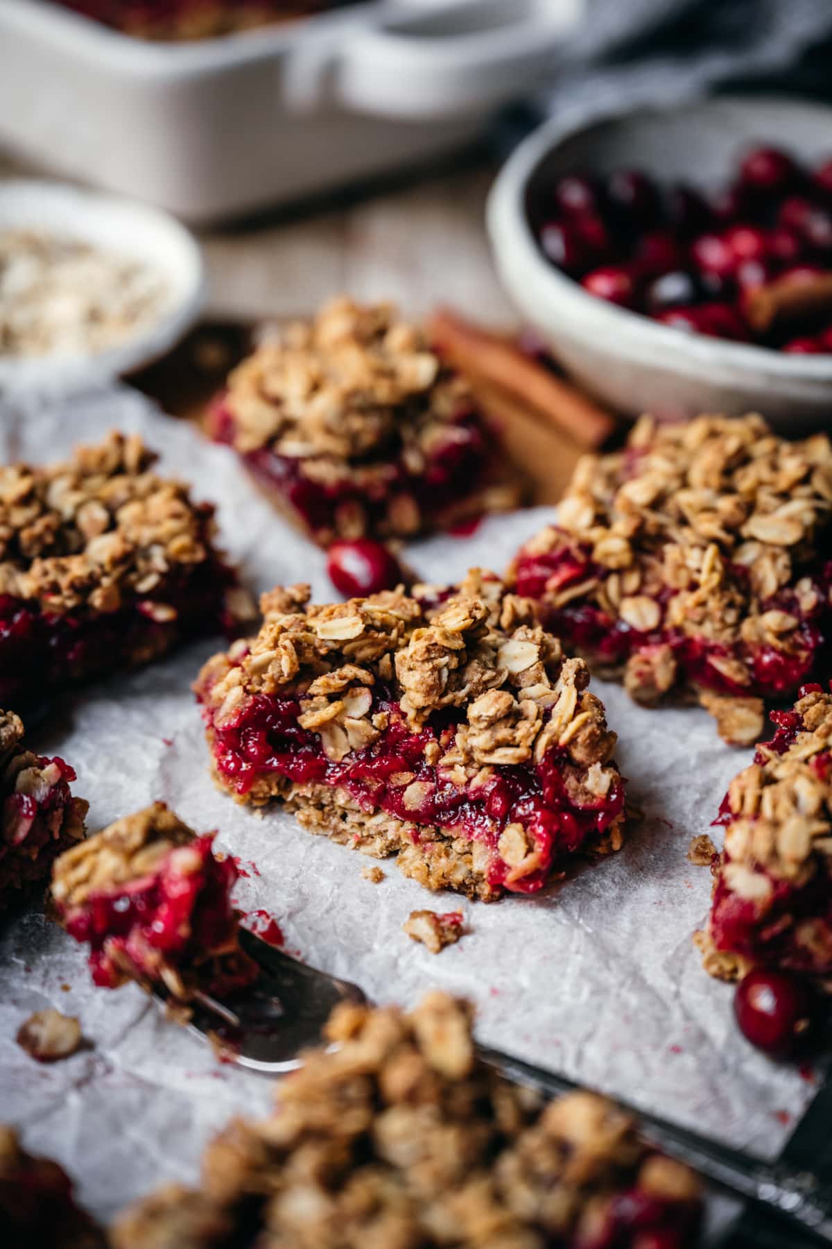 side view of vegan cranberry crumb bar cut in half with oat streusel topping.