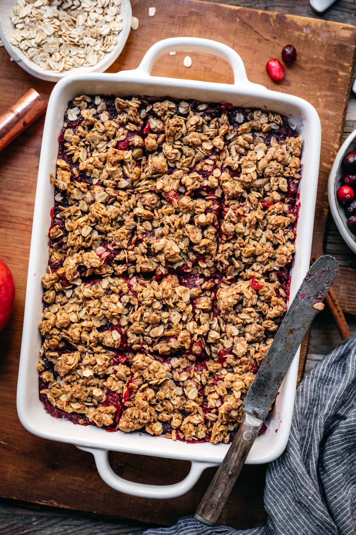 overhead view of cranberry oat crumb bars in a white pan.