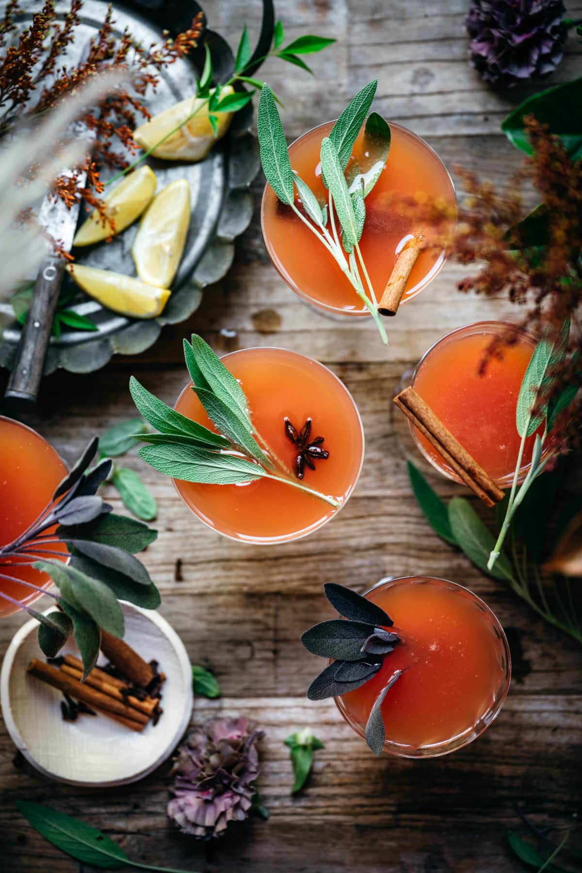 overhead view of cranberry orange mimosas garnished with fresh sage.