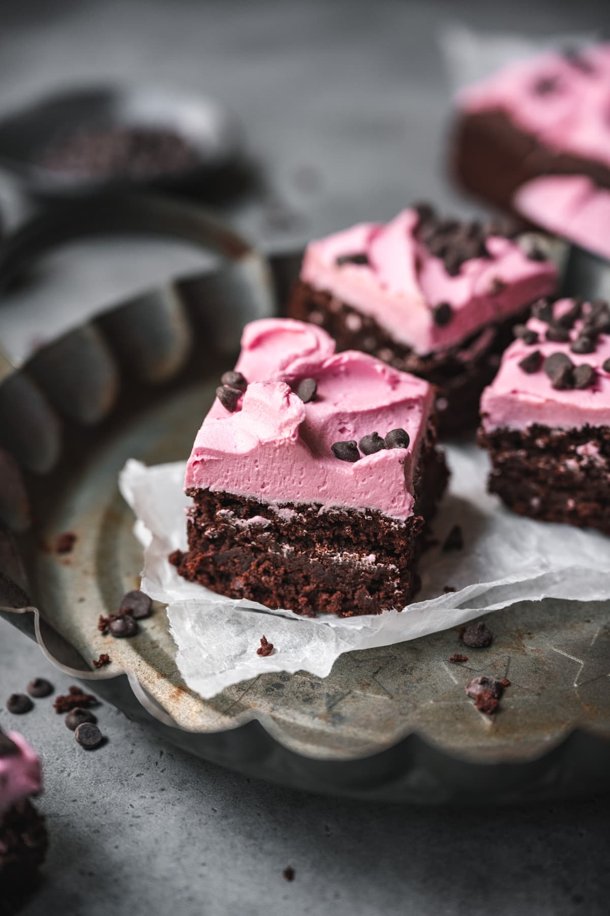 side view of vegan beet brownie topped with pink frosting.