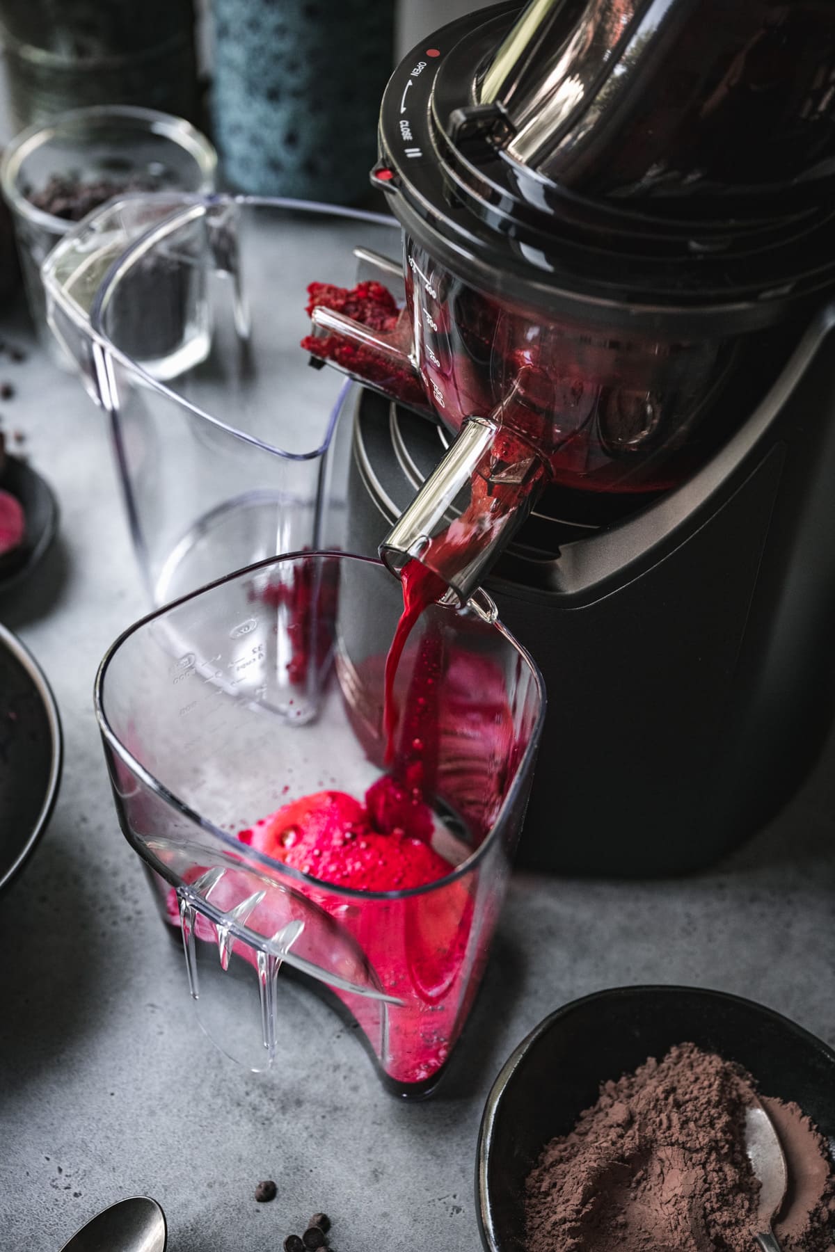 beet juice coming out of juicer.