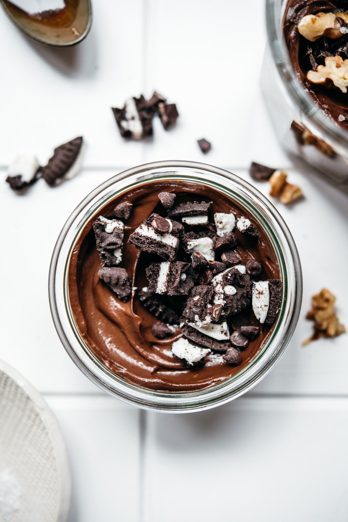 overhead view of jar of vegan chocolate mousse topped with crushed oreos.