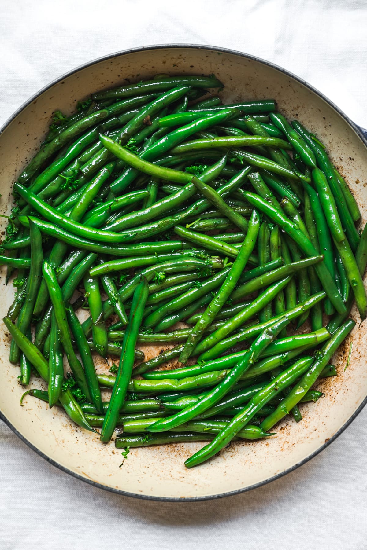 overhead view of sautéed green beans in a pan.