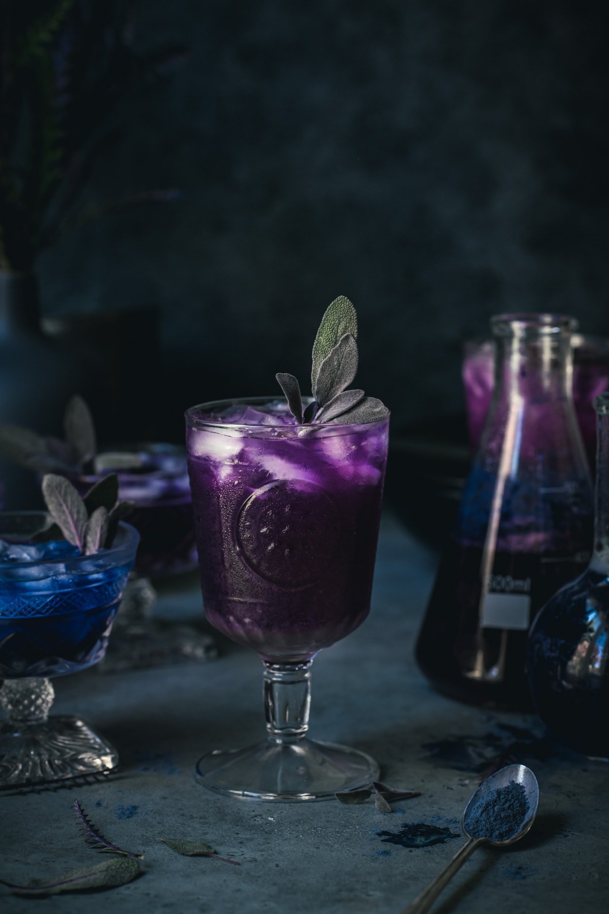 side view of a purple polyjuice potion cocktail in a glass.