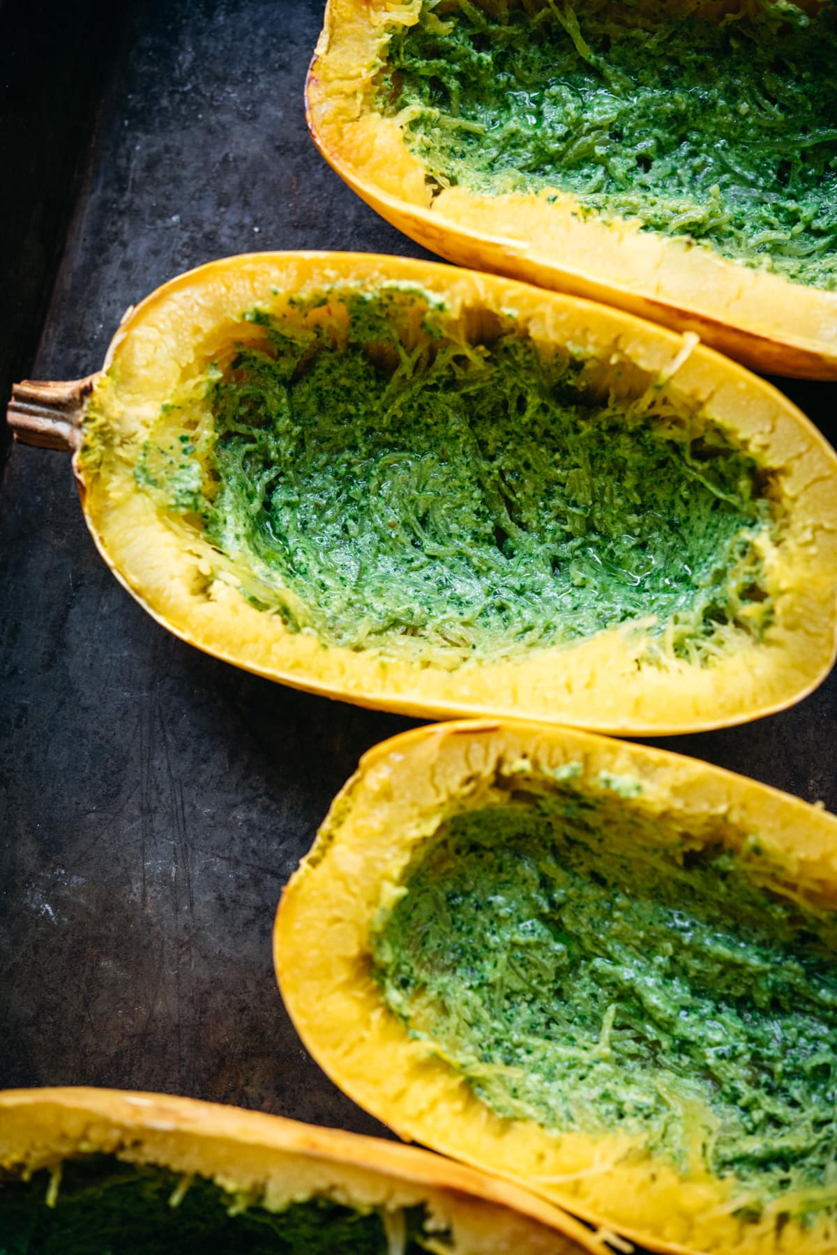 spaghetti squash with pesto spread on bottom.