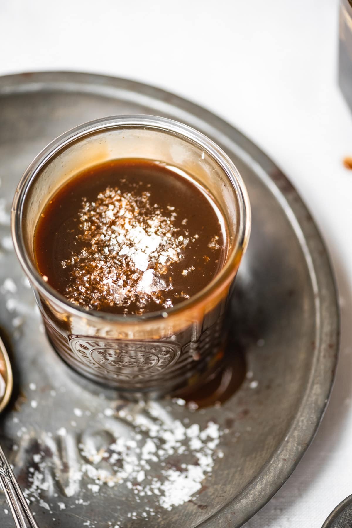 close up view of vegan salted caramel in a glass jar. 