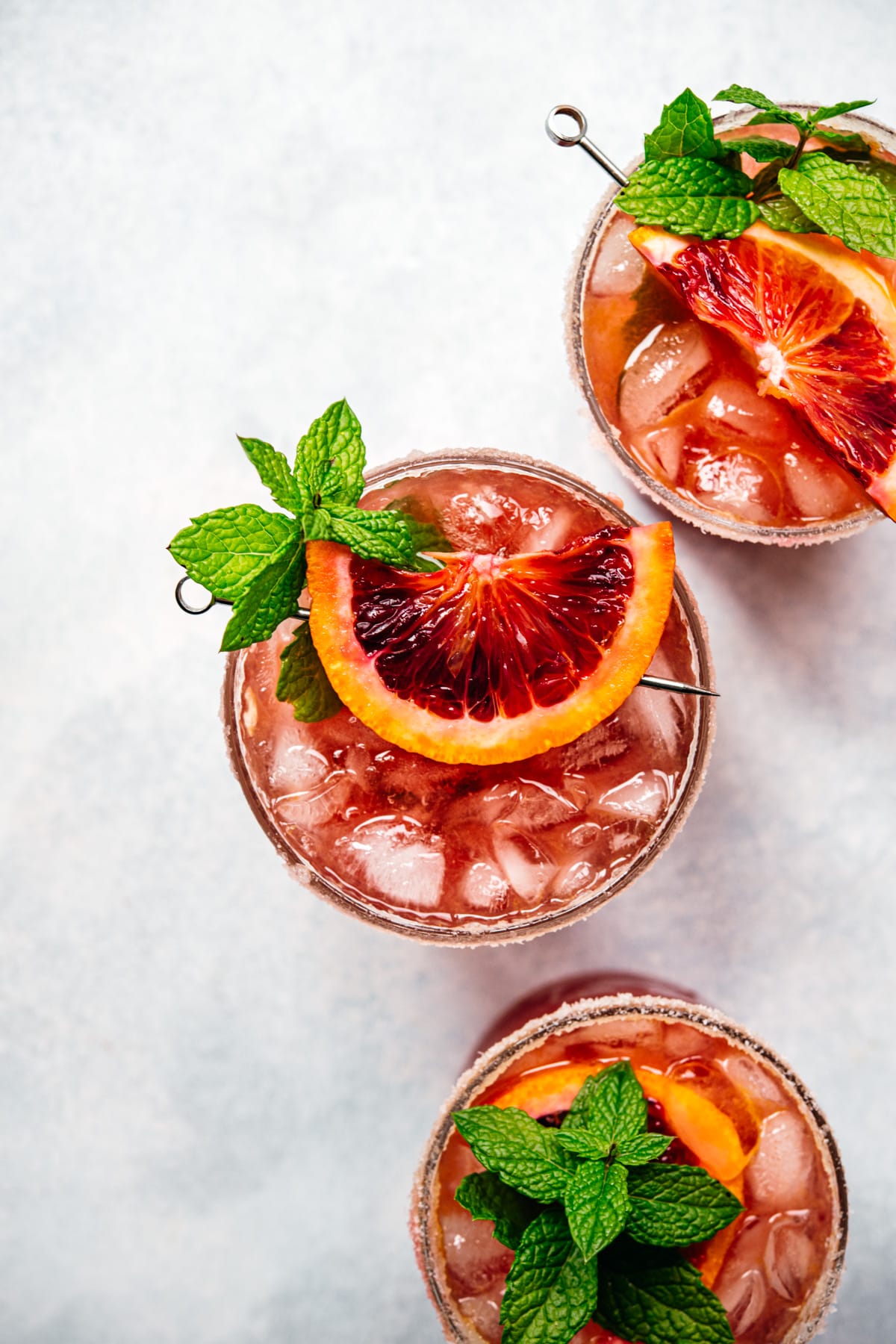 overhead view of three red blood orange margaritas. 