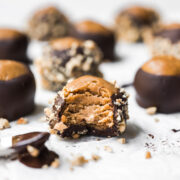 side view of vegan peanut butter buckeye with bite taken out.