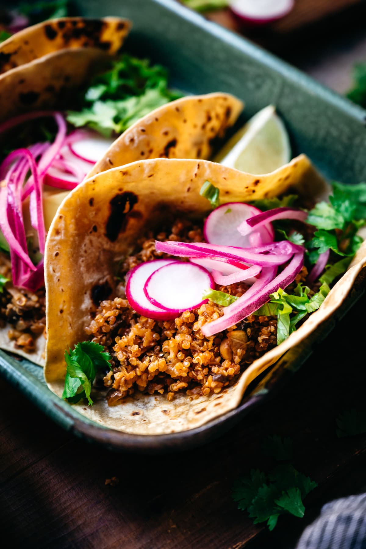 close up view of taco with vegan cauliflower quinoa taco meat and pickled onion. 