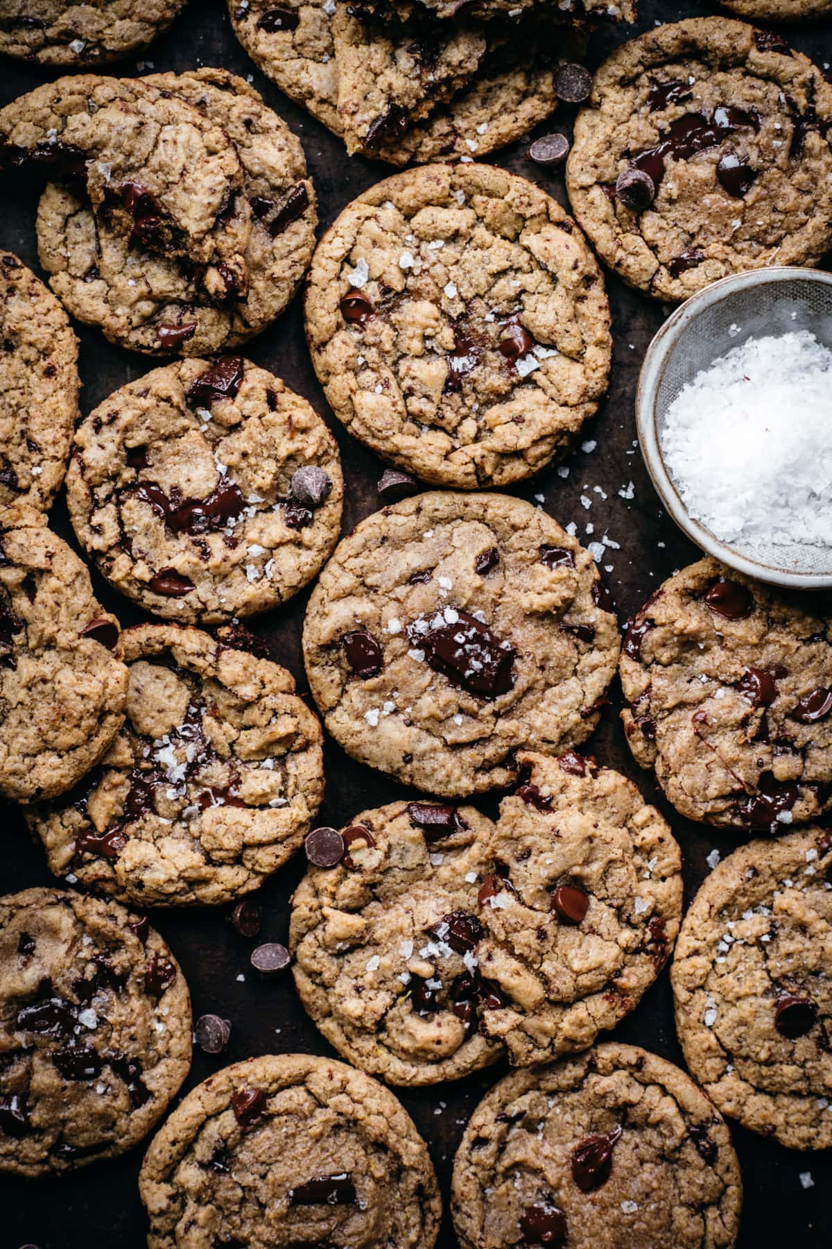 overhead view of vegan and gluten free chocolate chip cookies on sheet pan. 