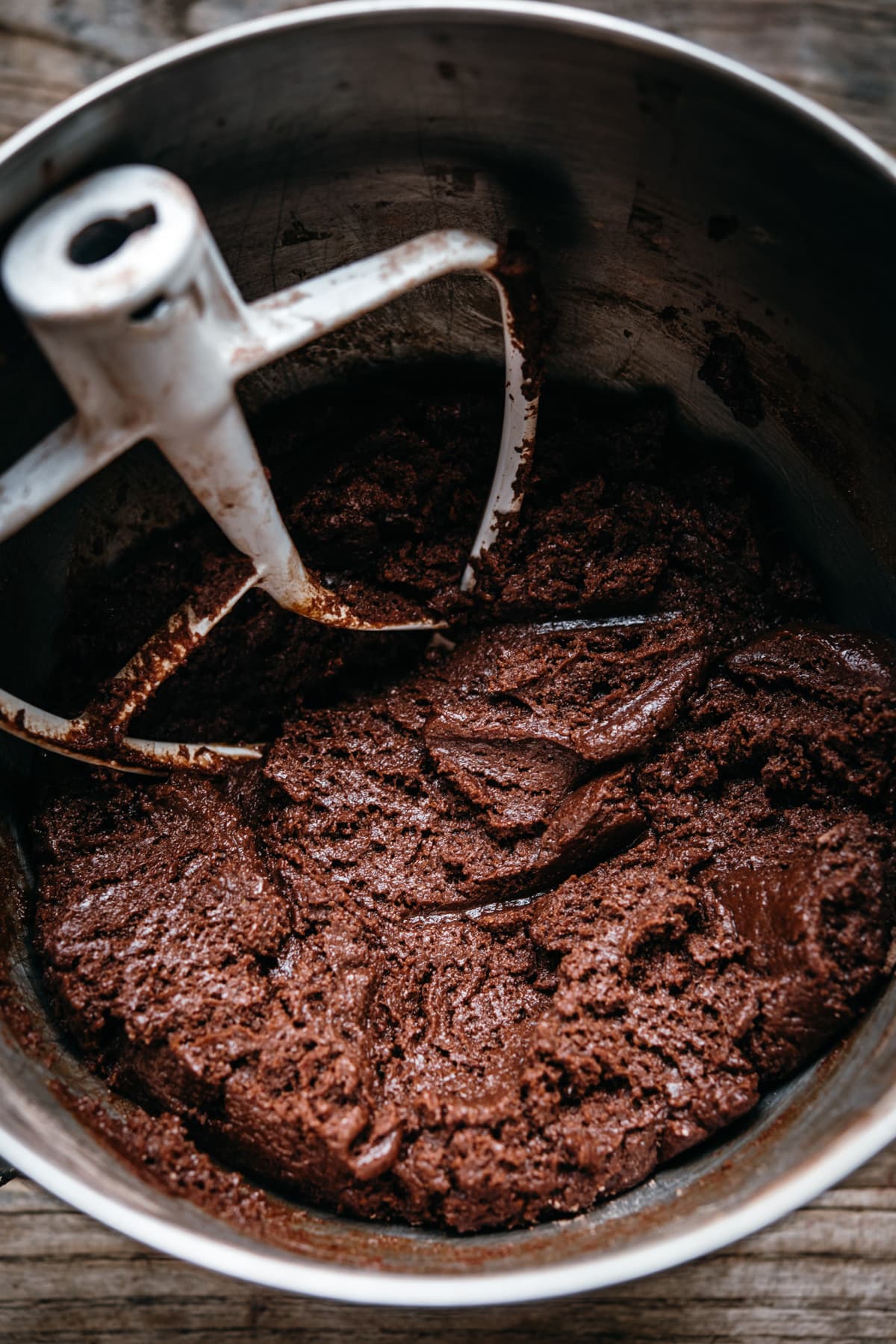 close up view of chocolate cookie dough in mixing bowl.