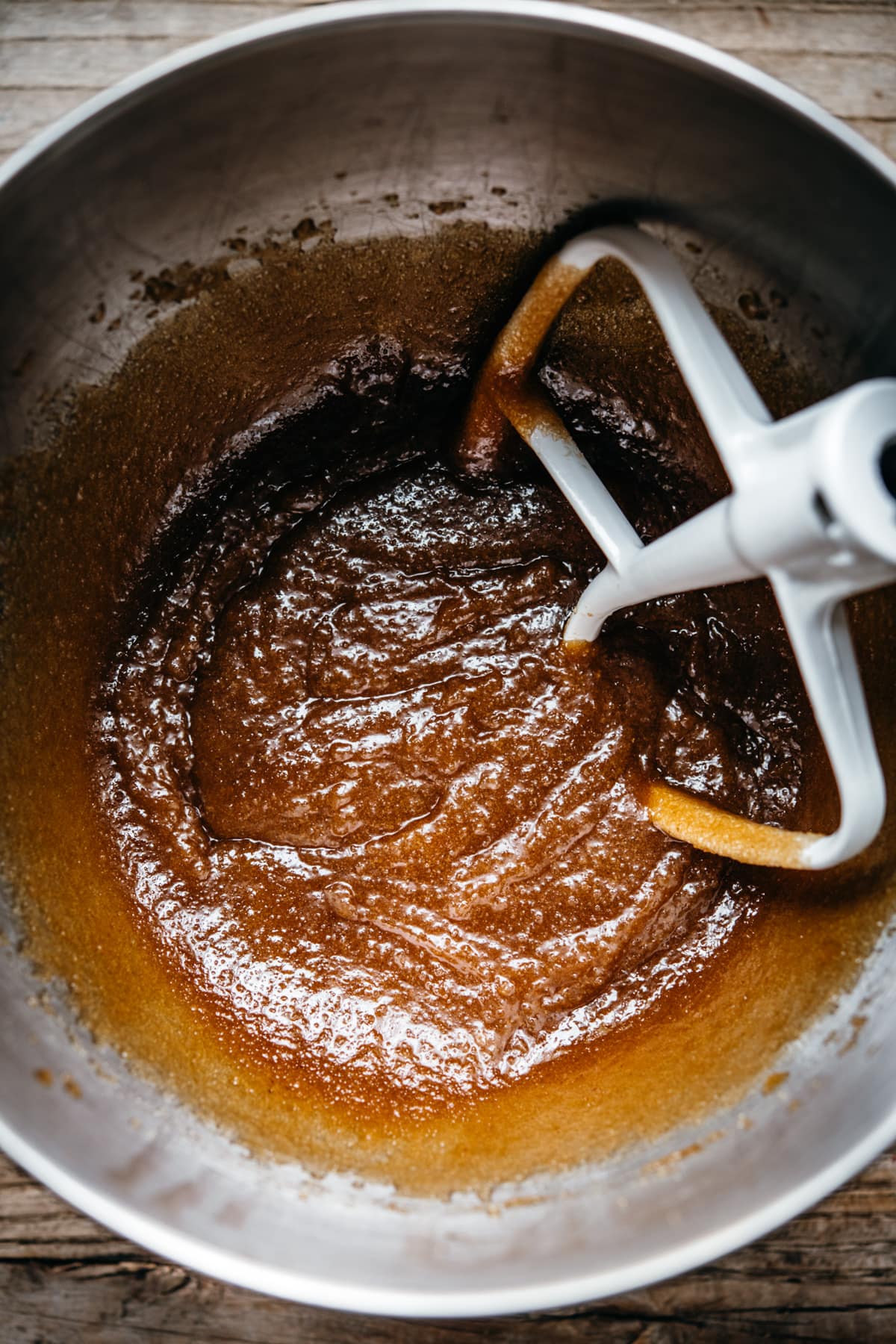 overhead view of melted butter and sugar creamed together in mixing bowl.