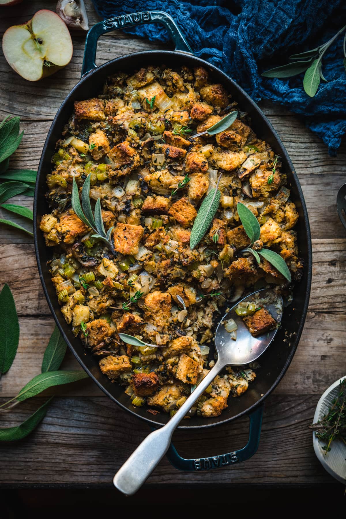 overhead view of gluten free vegan stuffing in an oval pan with serving spoon. 