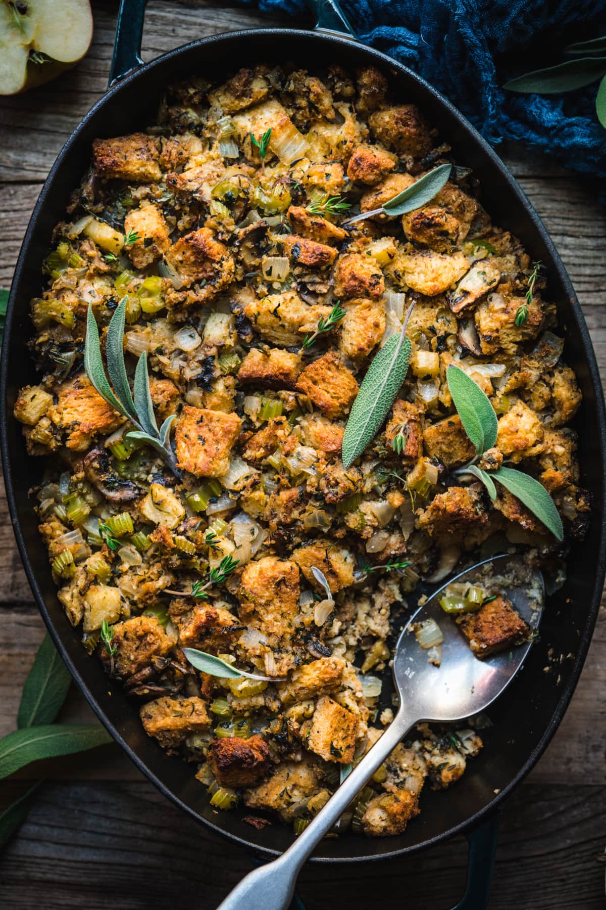 close up overhead view of gluten free vegan stuffing in a pan with fresh sage on top.
