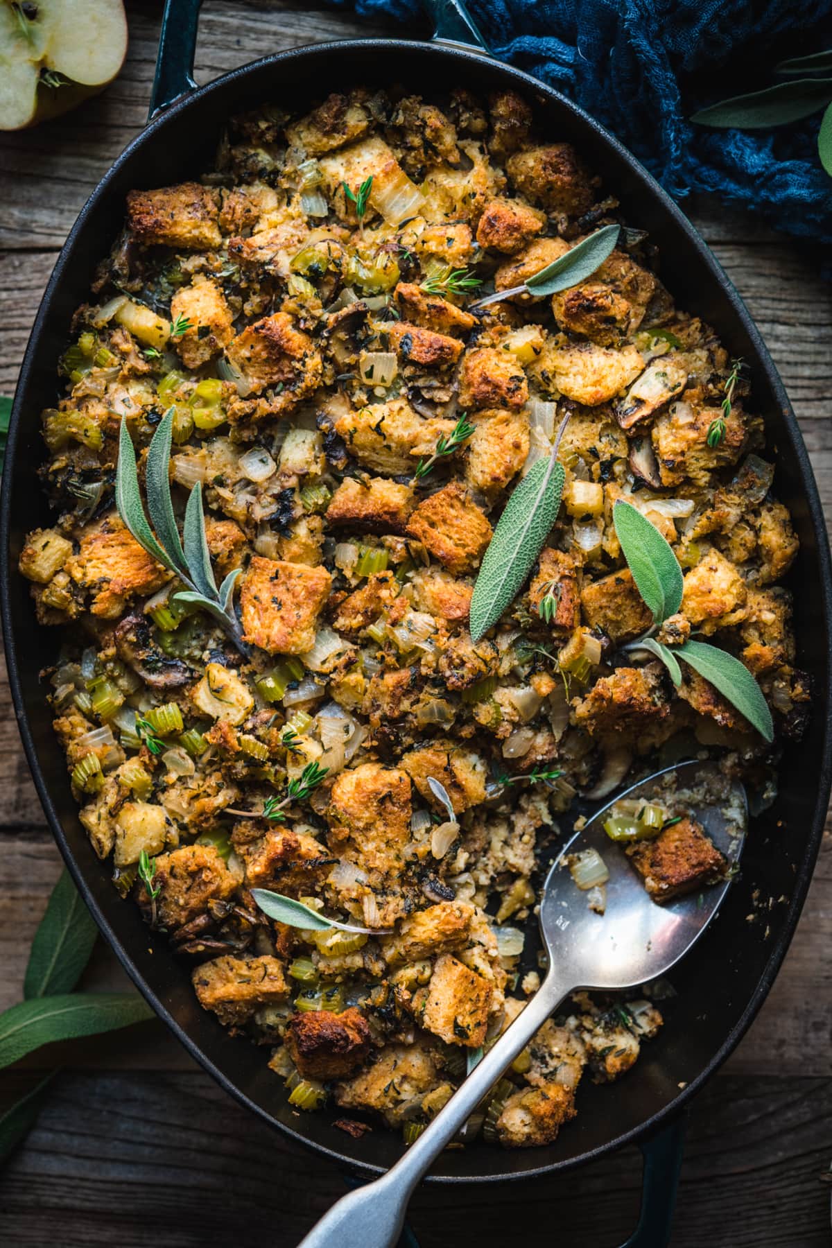 close up overhead view of gluten free vegan stuffing in a pan with fresh sage on top. 