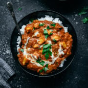 overhead view of vegan tofu tikka masala in a bowl with white rice.