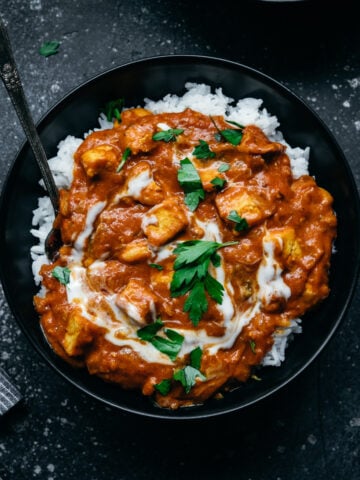 overhead view of vegan tofu tikka masala in a bowl with white rice.