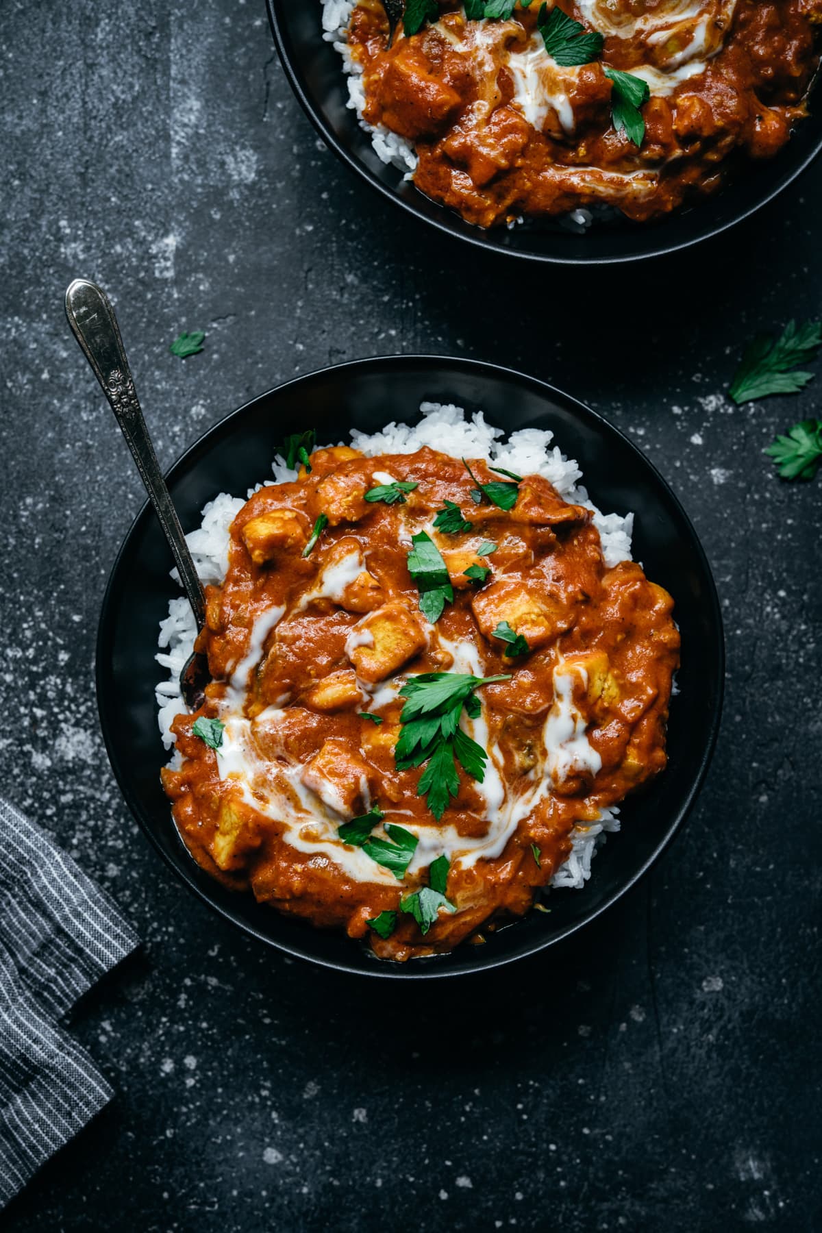 overhead view of vegan tofu tikka masala in a bowl with white rice. 