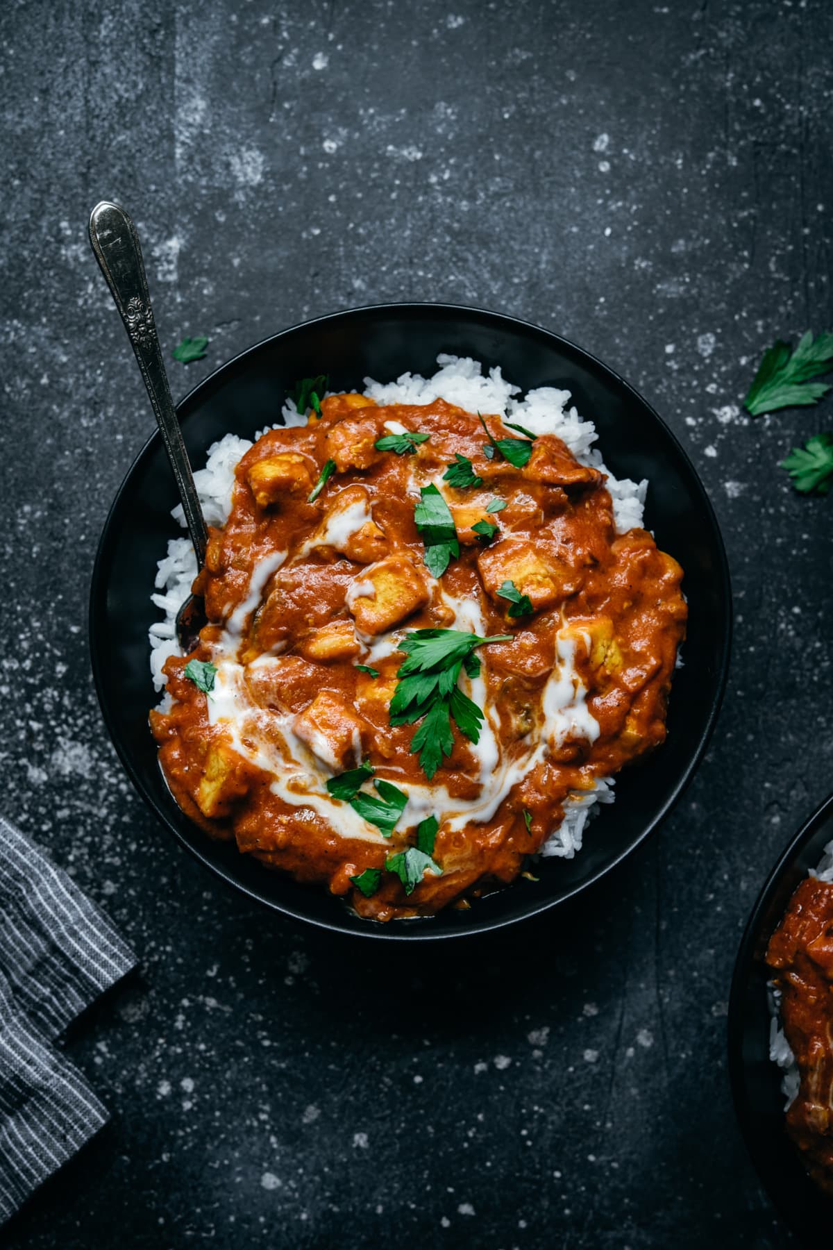 overhead view of vegan tofu tikka masala in a bowl with white rice. 
