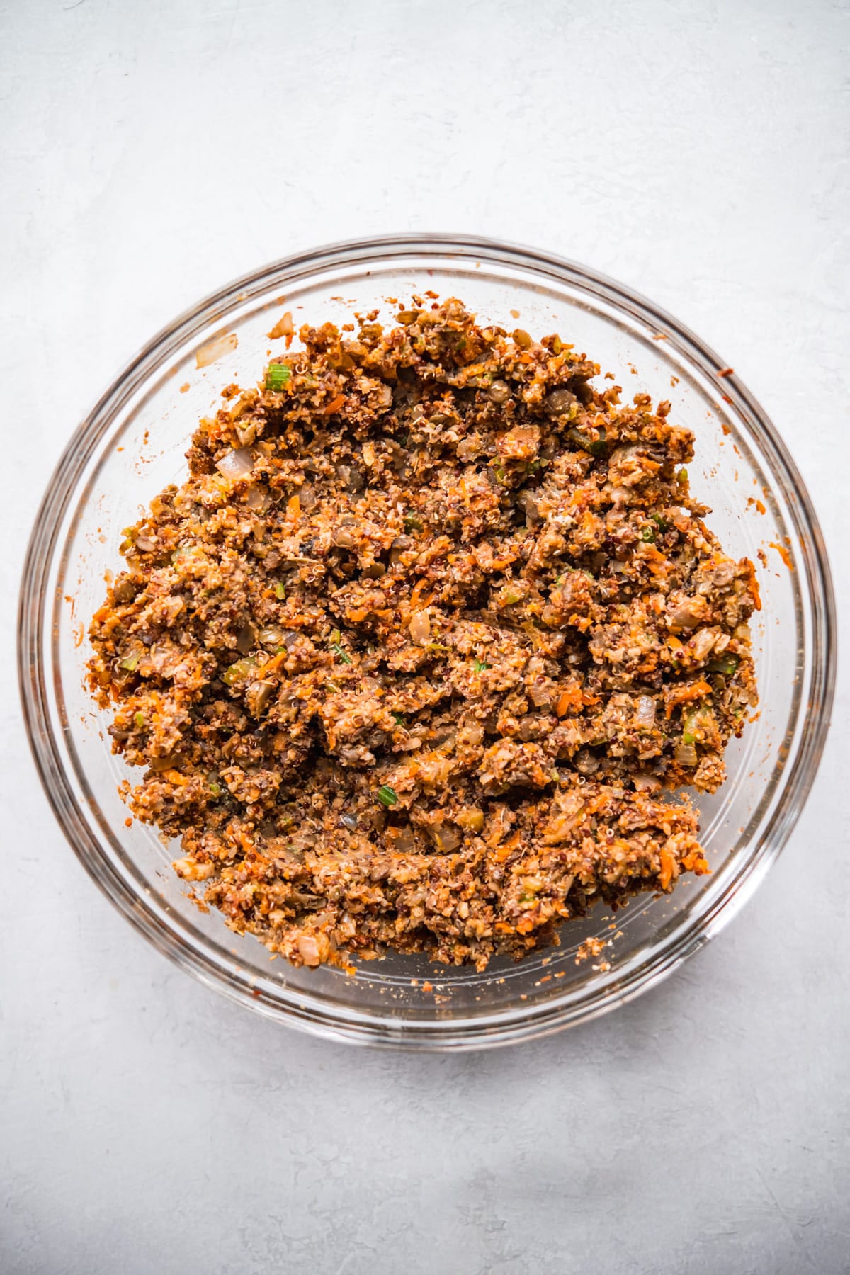 Glass bowl with ingredients for vegan meatloaf, mixed. 