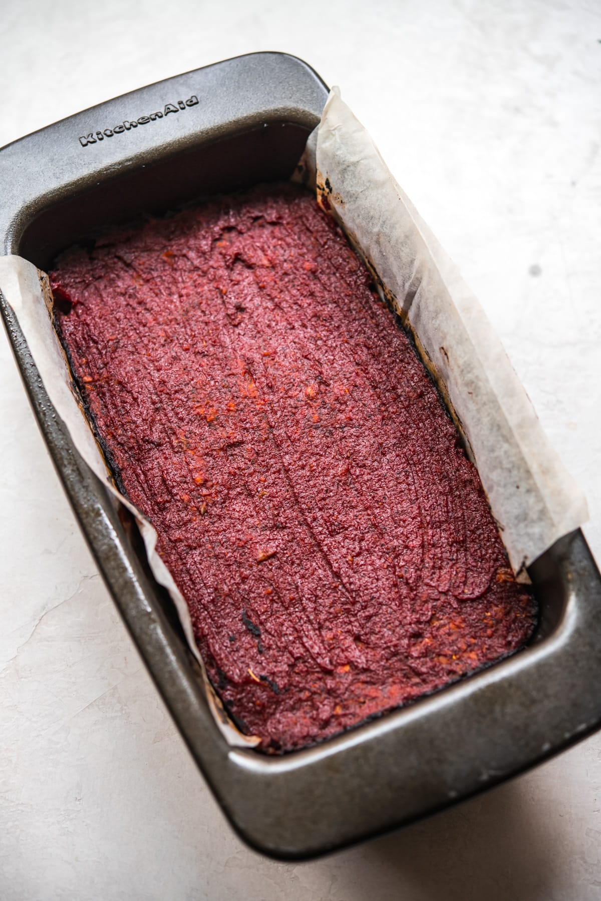 side view of baked vegan meatloaf in a loaf pan.