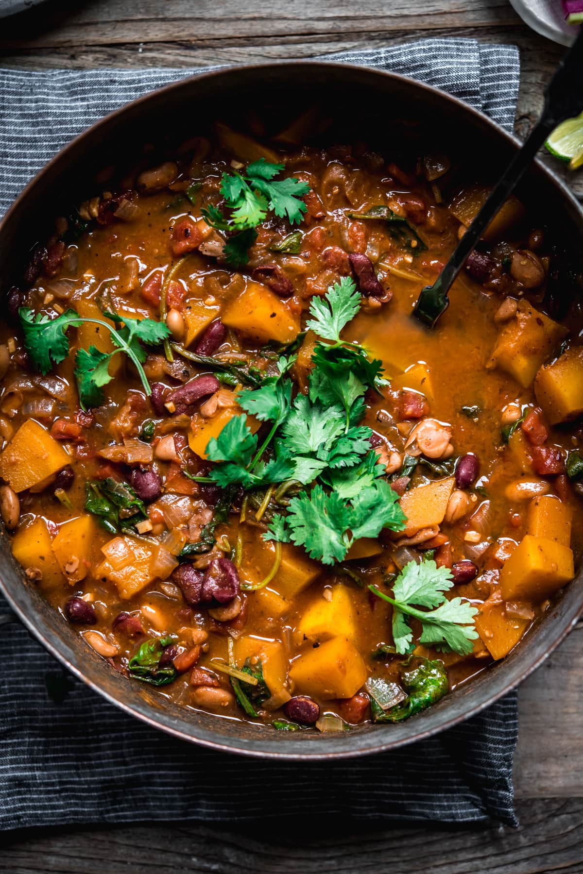 overhead view of vegan pumpkin and bean chili in a large pot.
