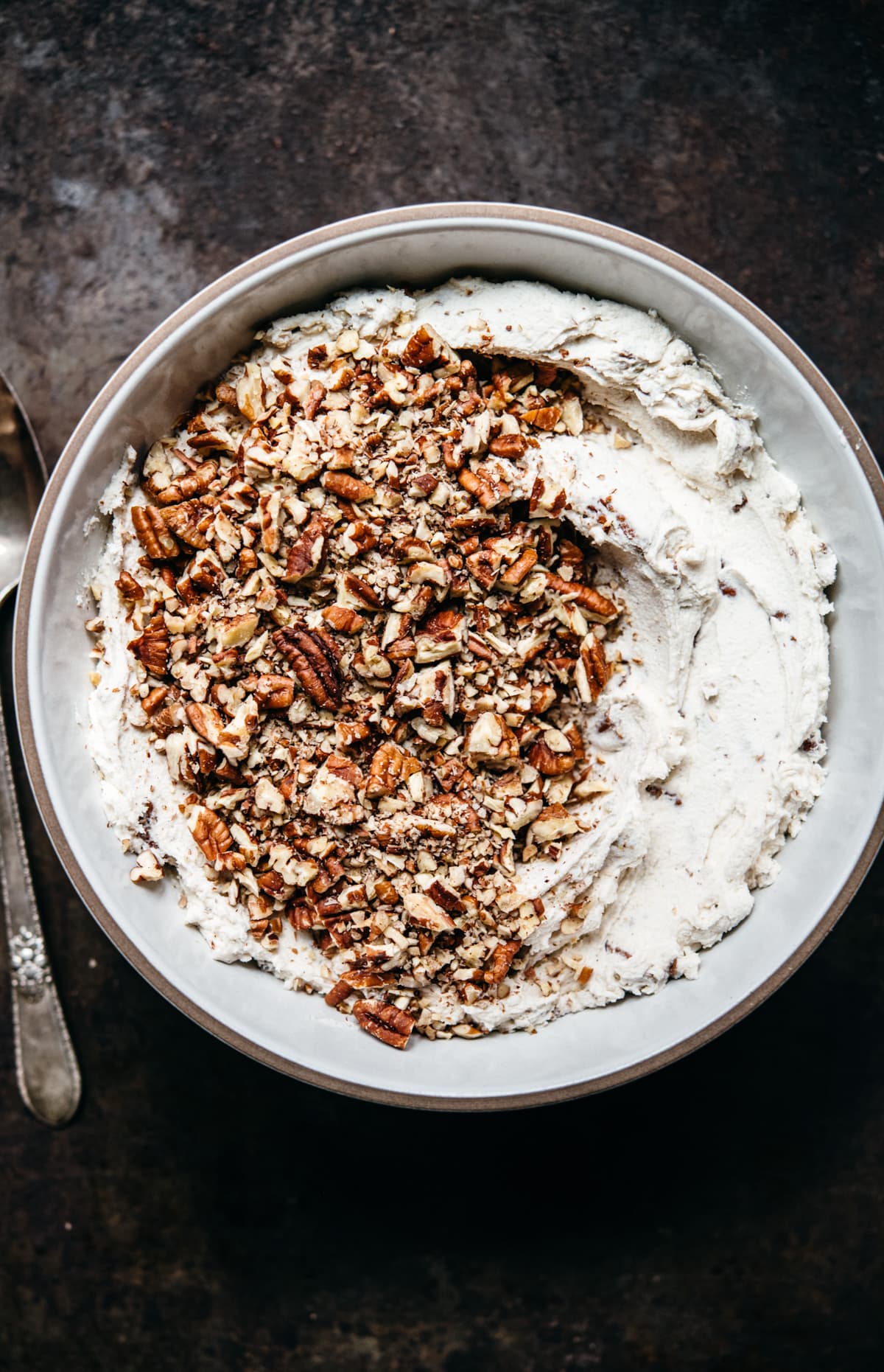 vegan pecan snowball cookie dough in a white bowl.