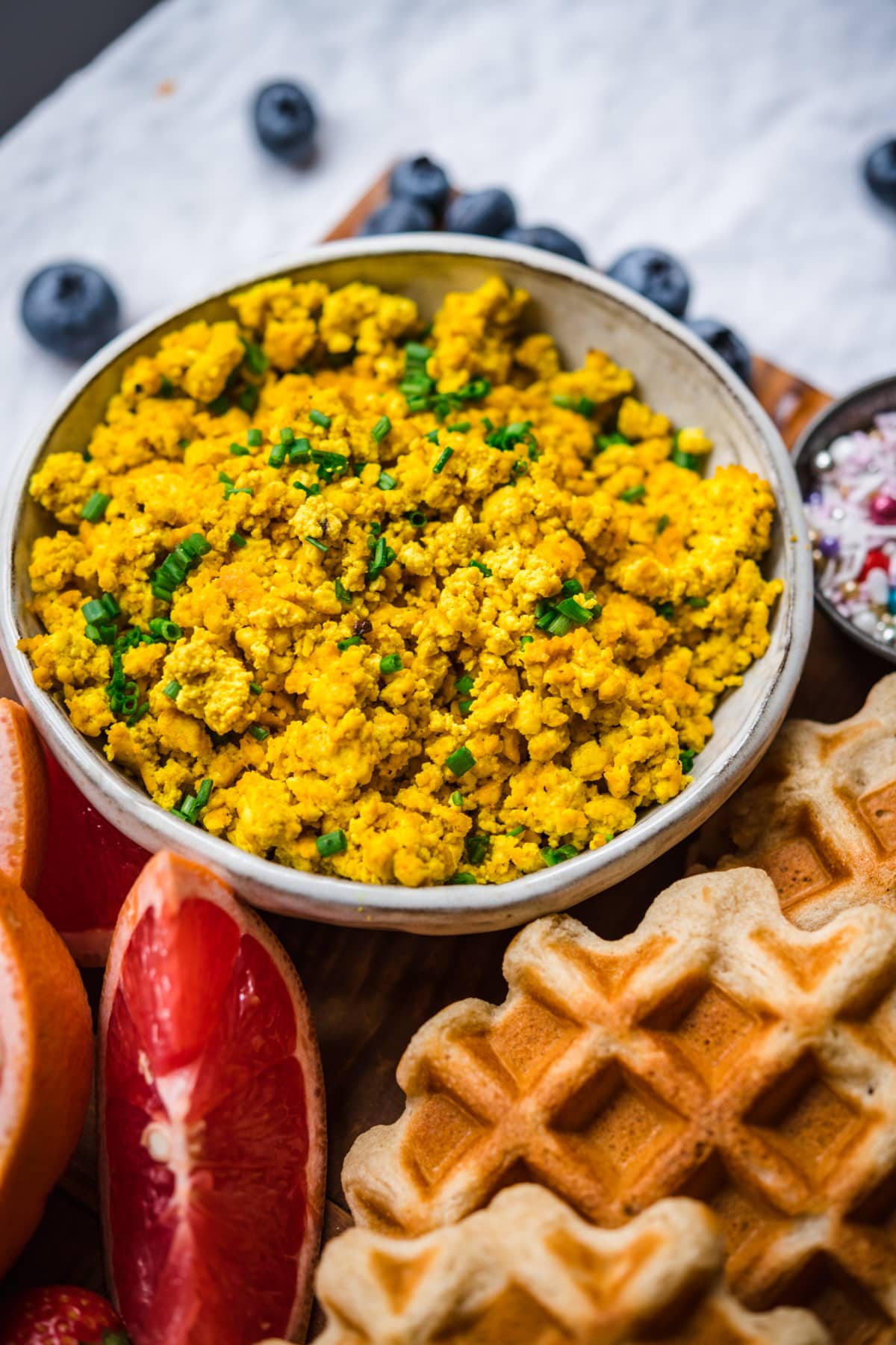 close up view of scrambled tofu in a bowl.