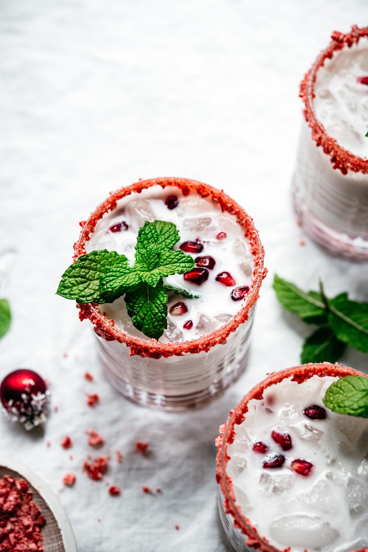 45 degree angle of white russian cocktail with peppermint rim.