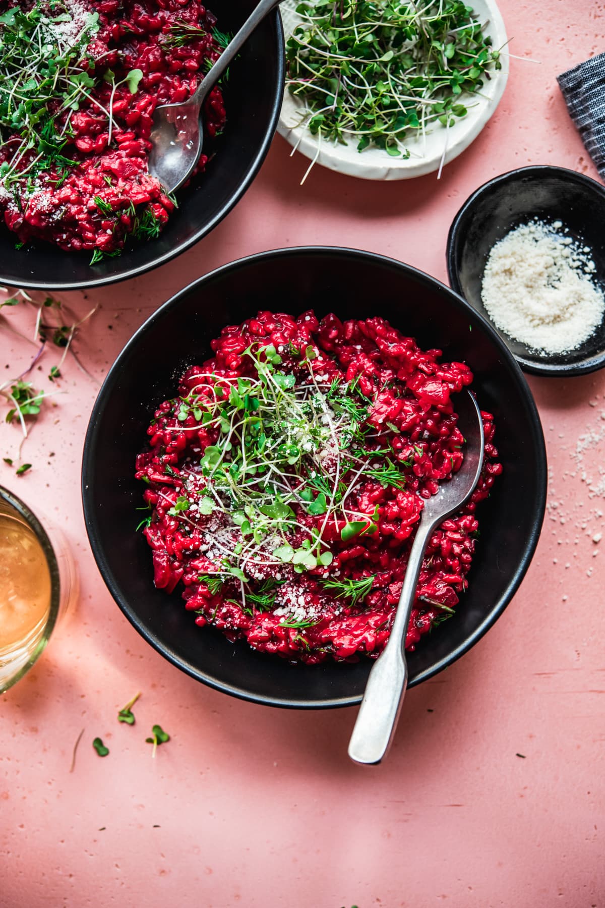 overhead view of vegan beet risotto topped with microgreens. 