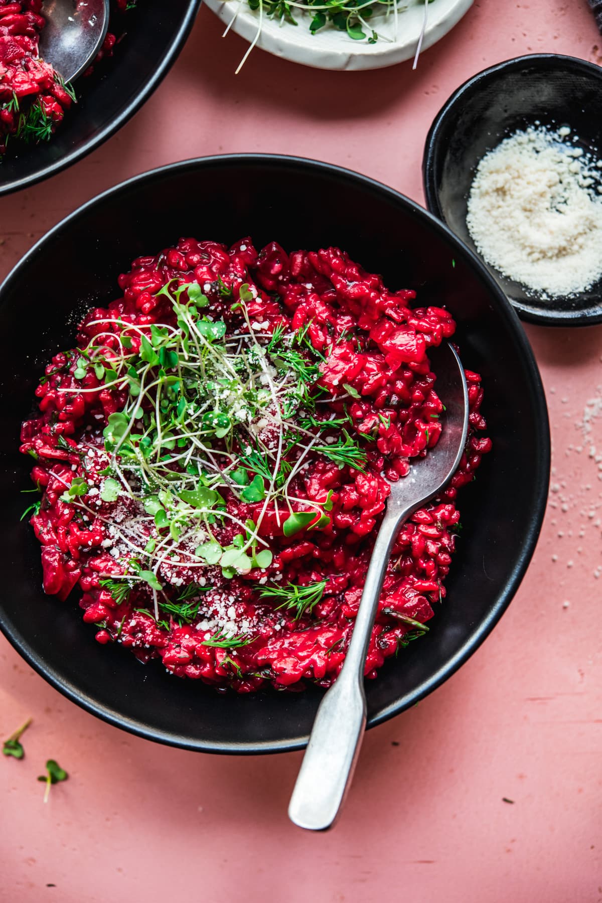 overhead view of vegan beet risotto topped with microgreens. 