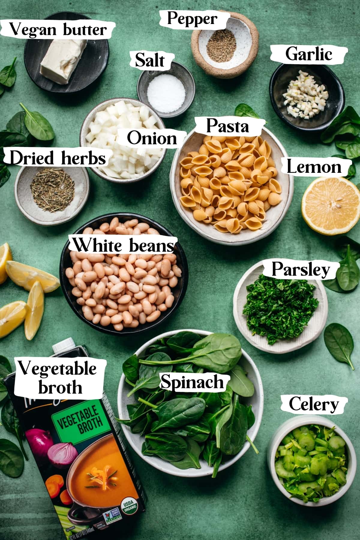 overhead view of ingredients for white bean spinach soup with text labels.