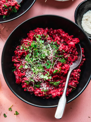 overhead view of vegan beet risotto topped with microgreens.
