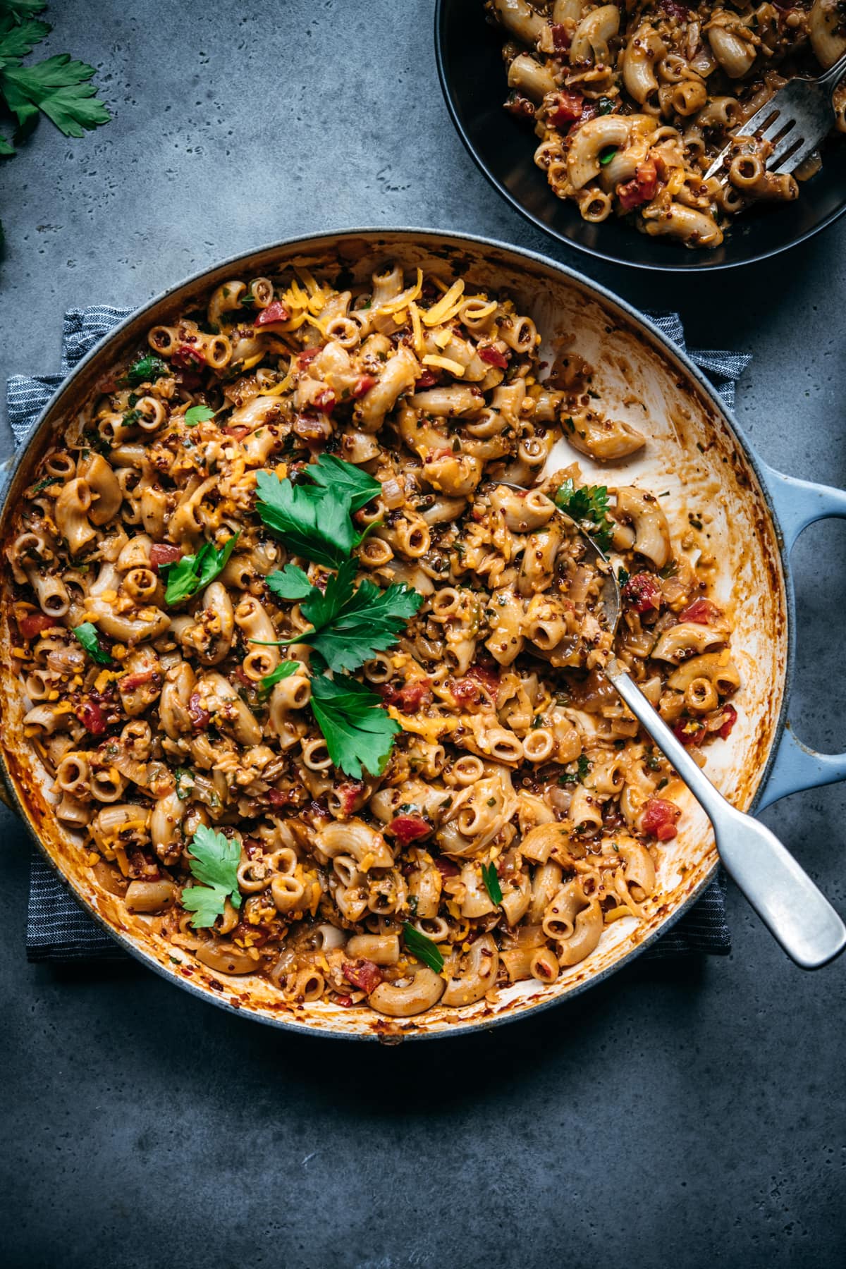 overhead view of vegan hamburger helper pasta in a large pot with serving spoon.