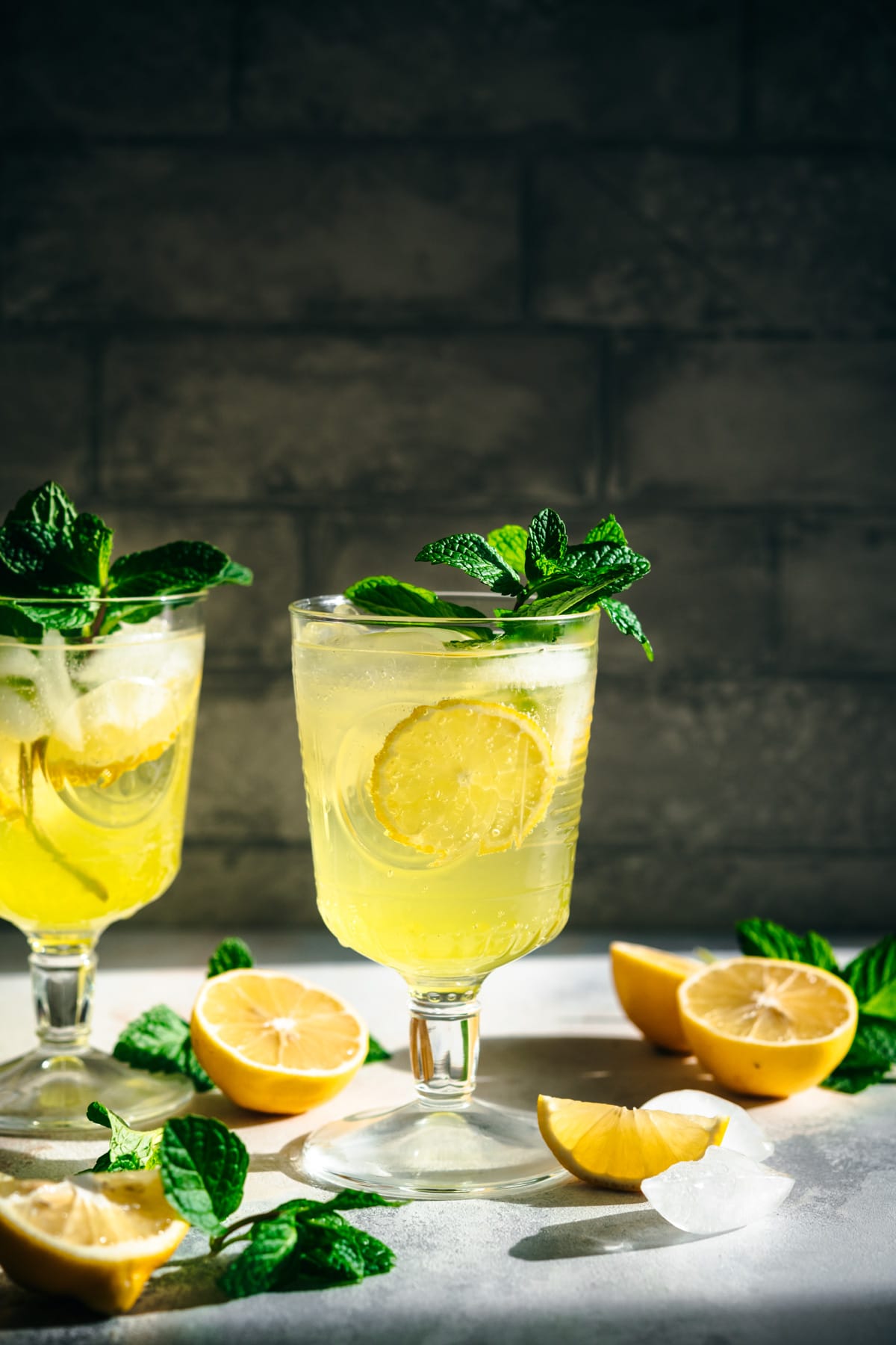 side view of limoncello spritz cocktail garnished with fresh mint. 