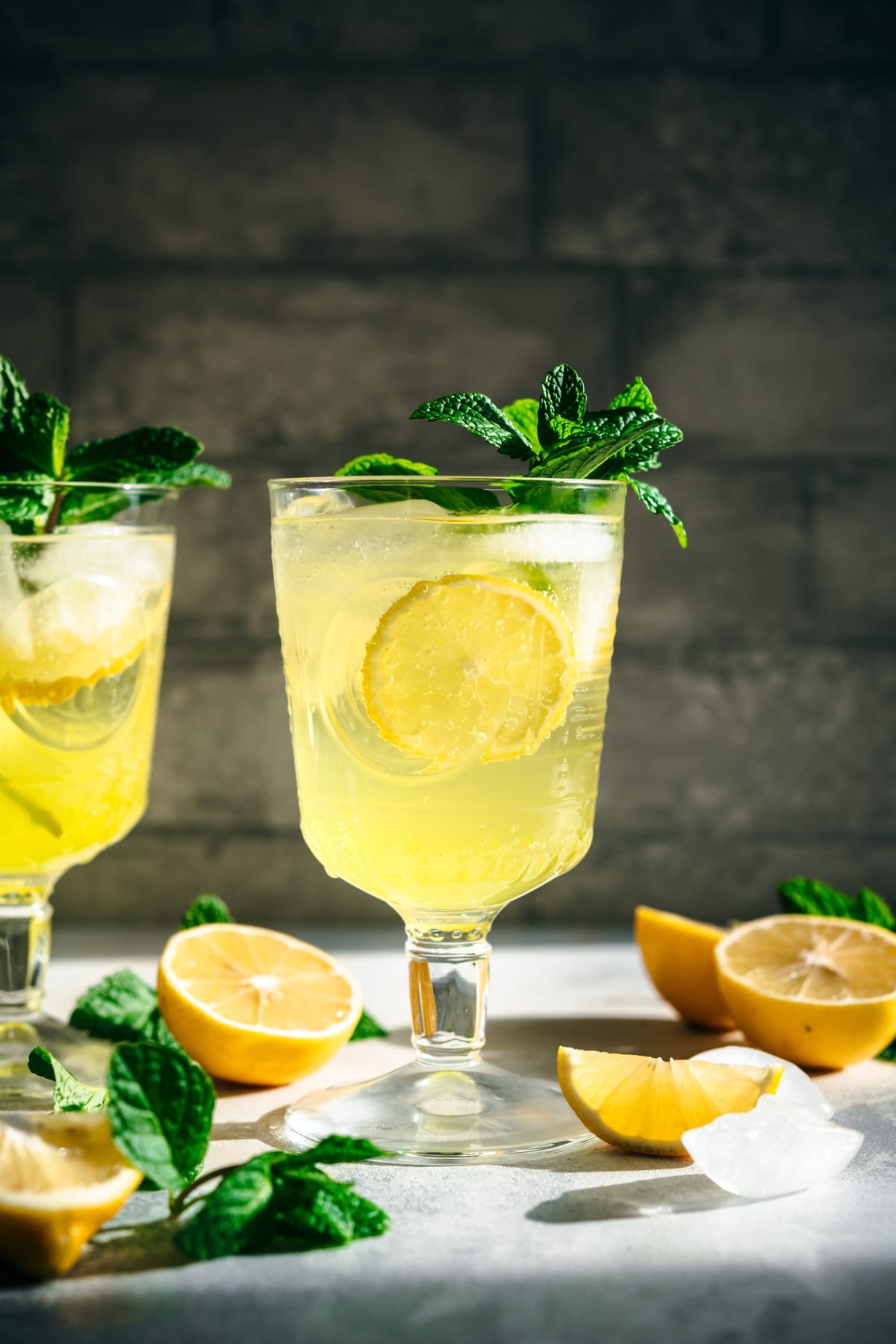 side view of limoncello spritz cocktail garnished with fresh mint. 
