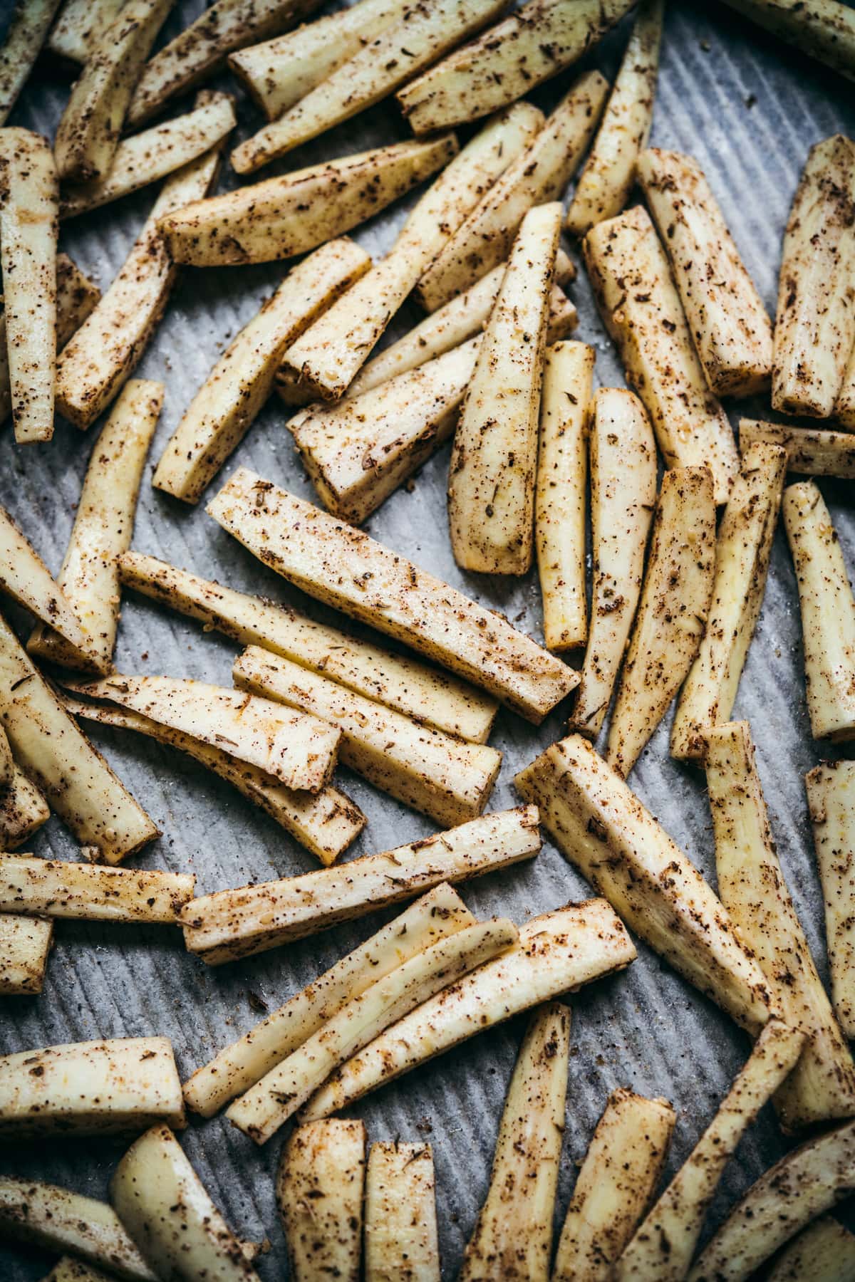 za'atar spiced parsnips on sheet pan before roasting. 