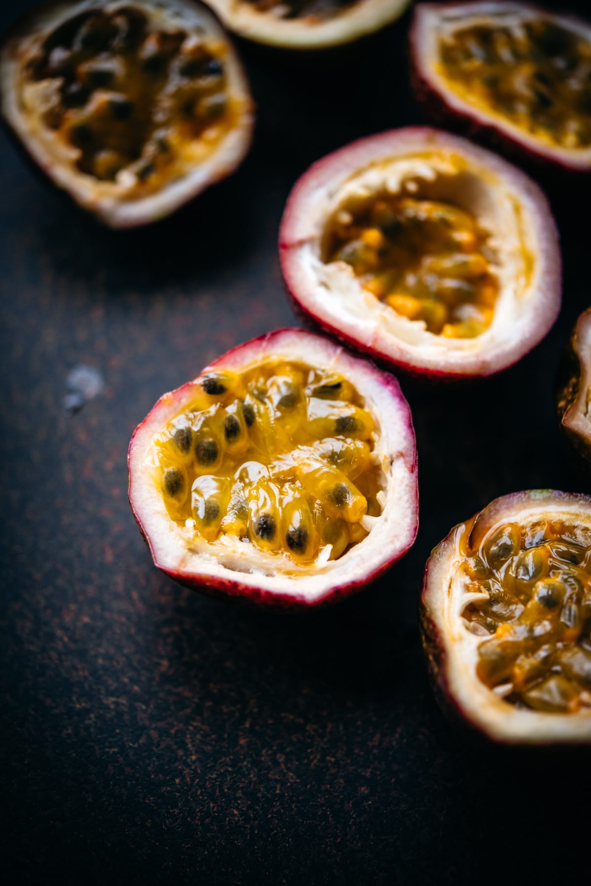 close up view of a passion fruit sliced in half. 