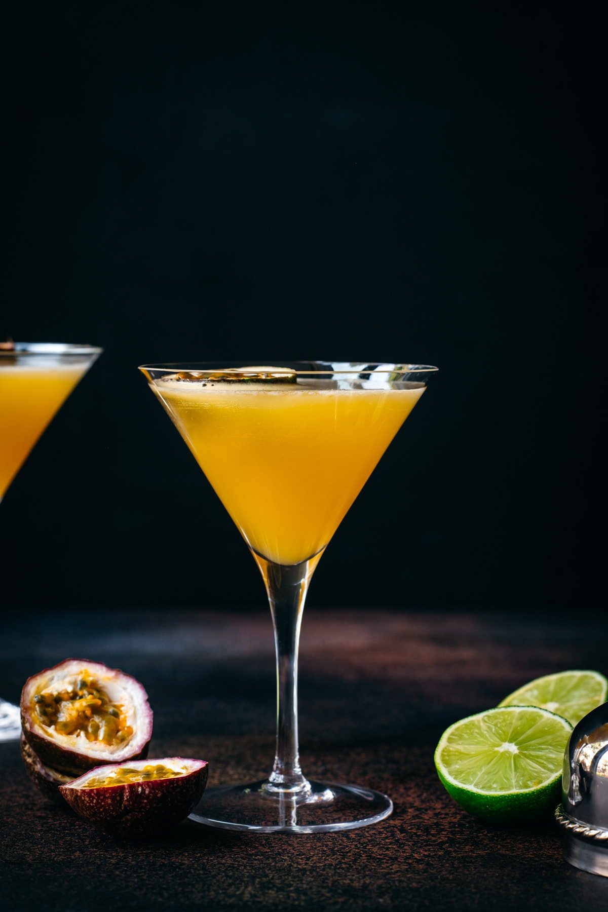 side view of passion fruit martini in a glass. 