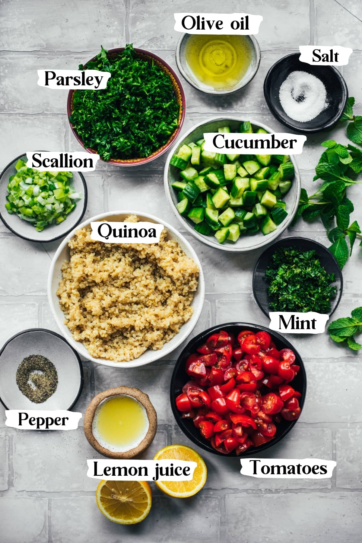 overhead view of ingredients for quinoa tabbouleh salad in small bowls. 