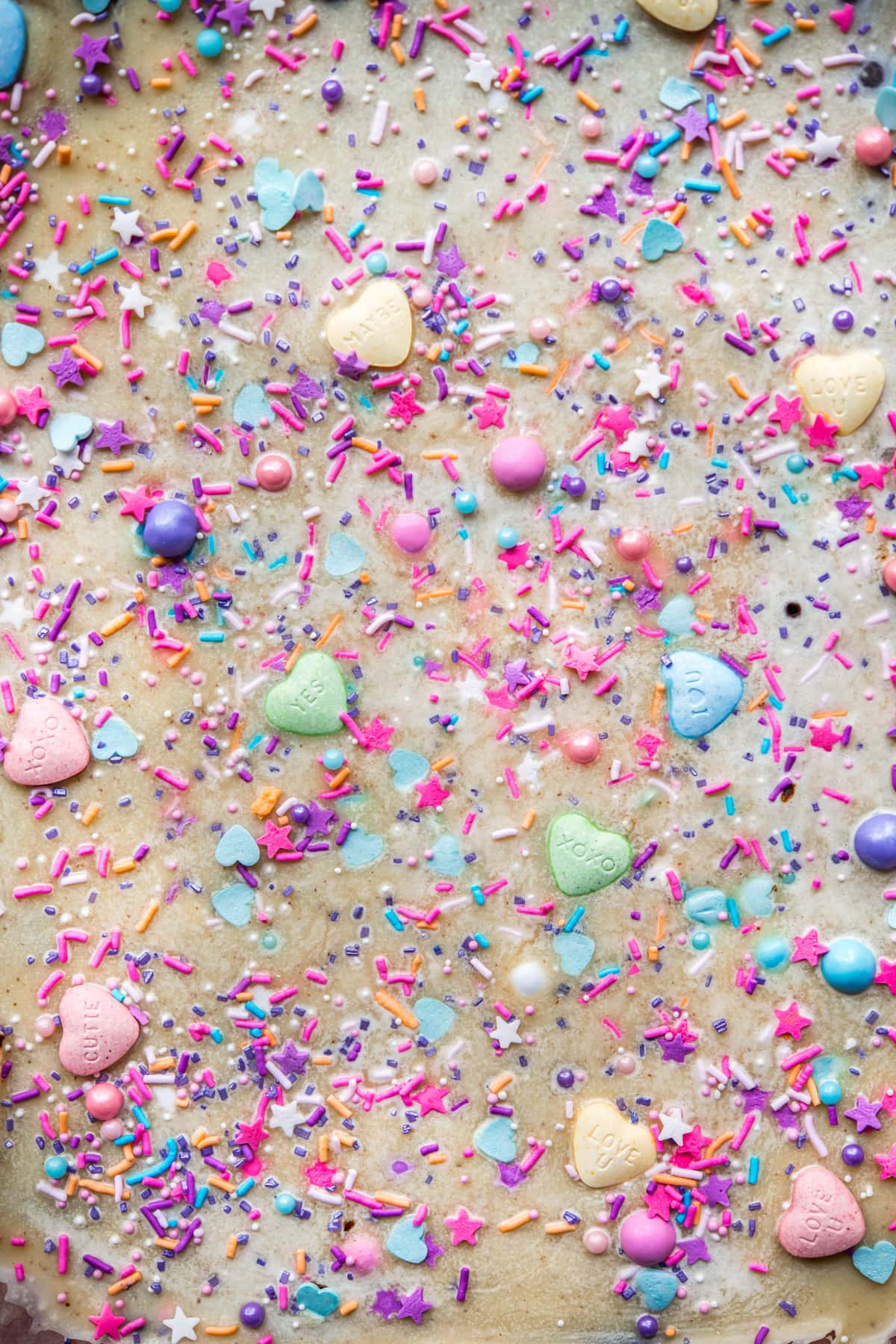 overhead view of vegan white chocolate bark topped with sprinkles.