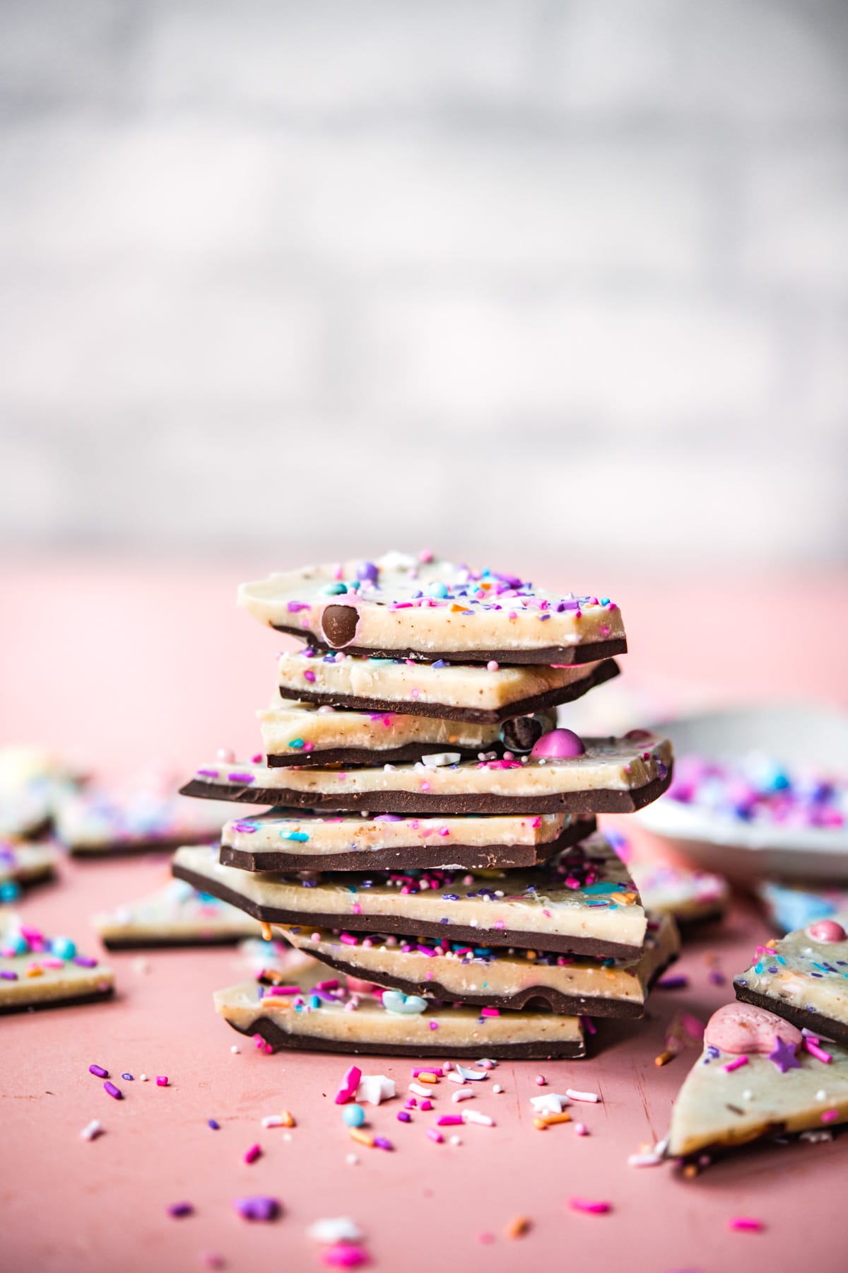 side view of stack of vegan white chocolate bark pieces.