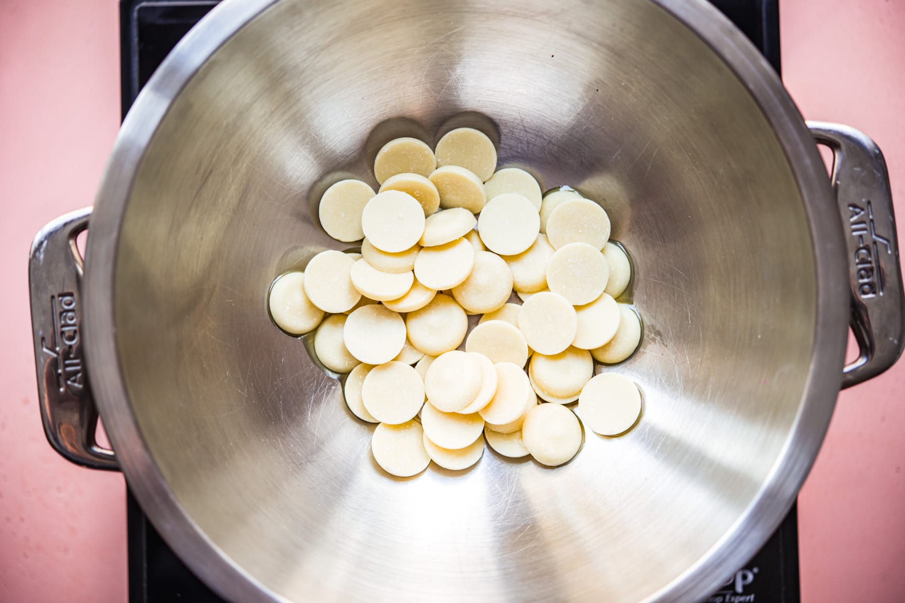 overhead view of cacao butter wafers in a double boiler. 