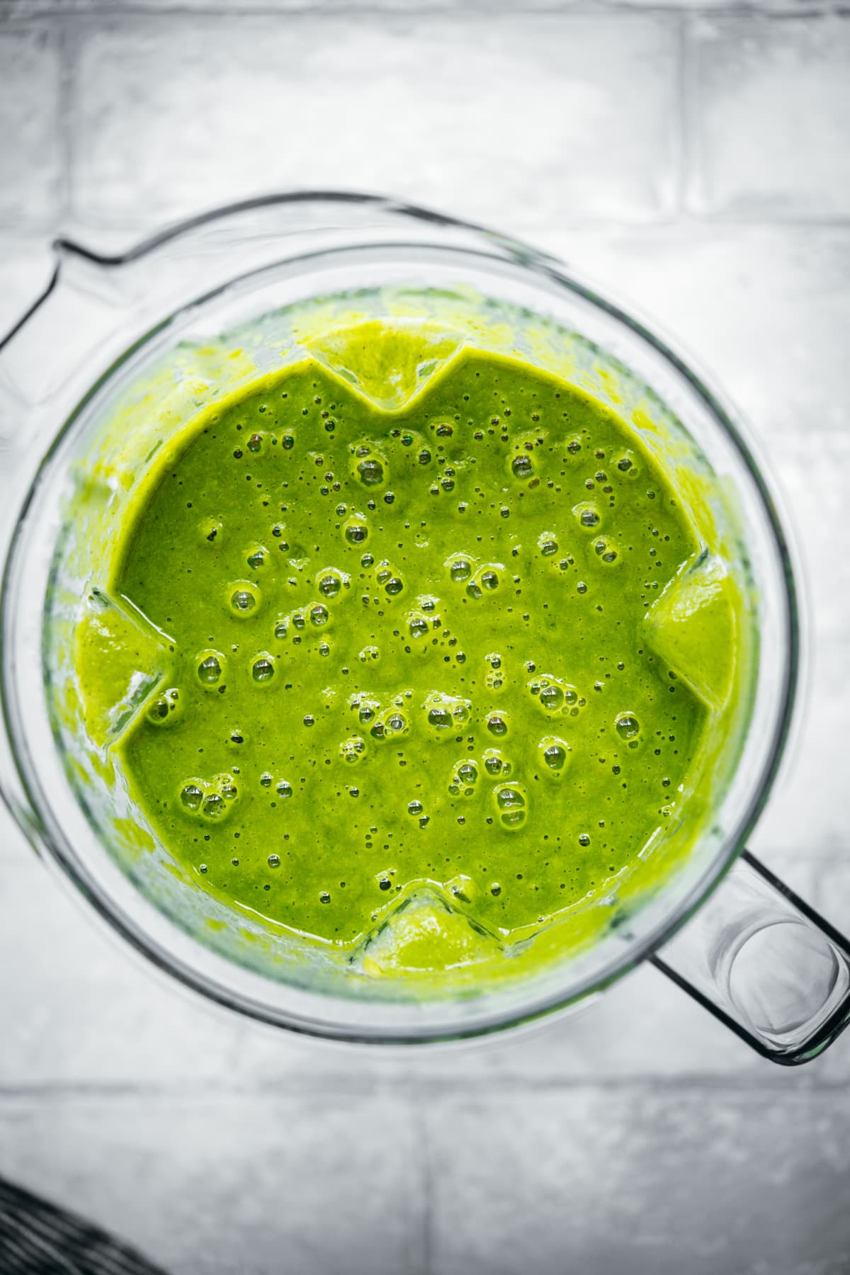 overhead view of creamy vegan potato kale soup in blender.