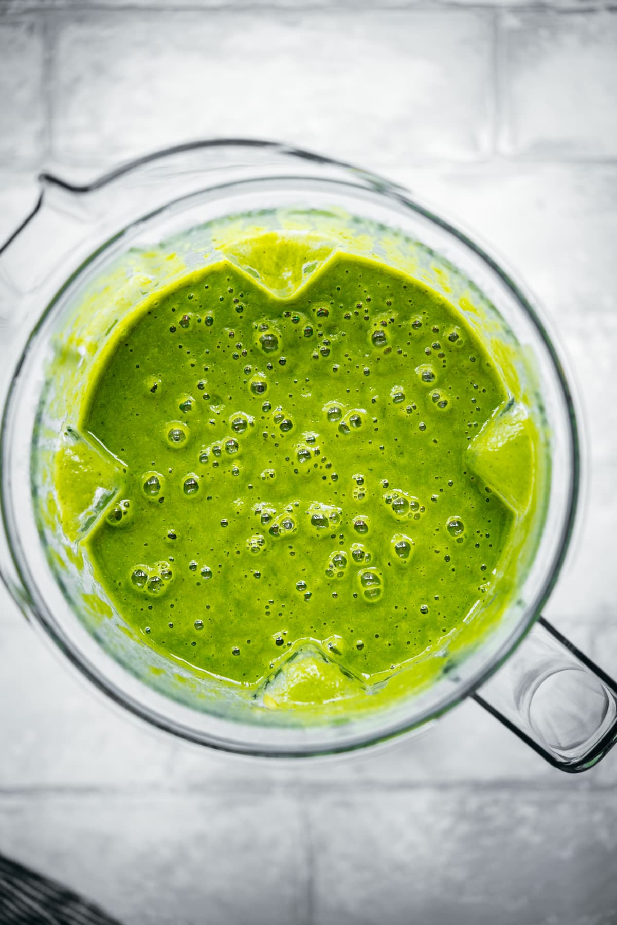 overhead view of creamy vegan potato kale soup in blender. 