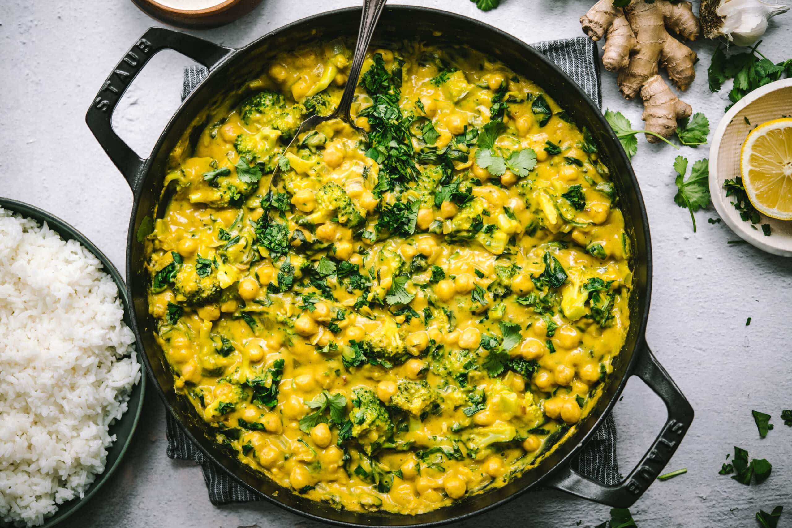 overhead view of vegan mango chickpea curry in a large skillet. 