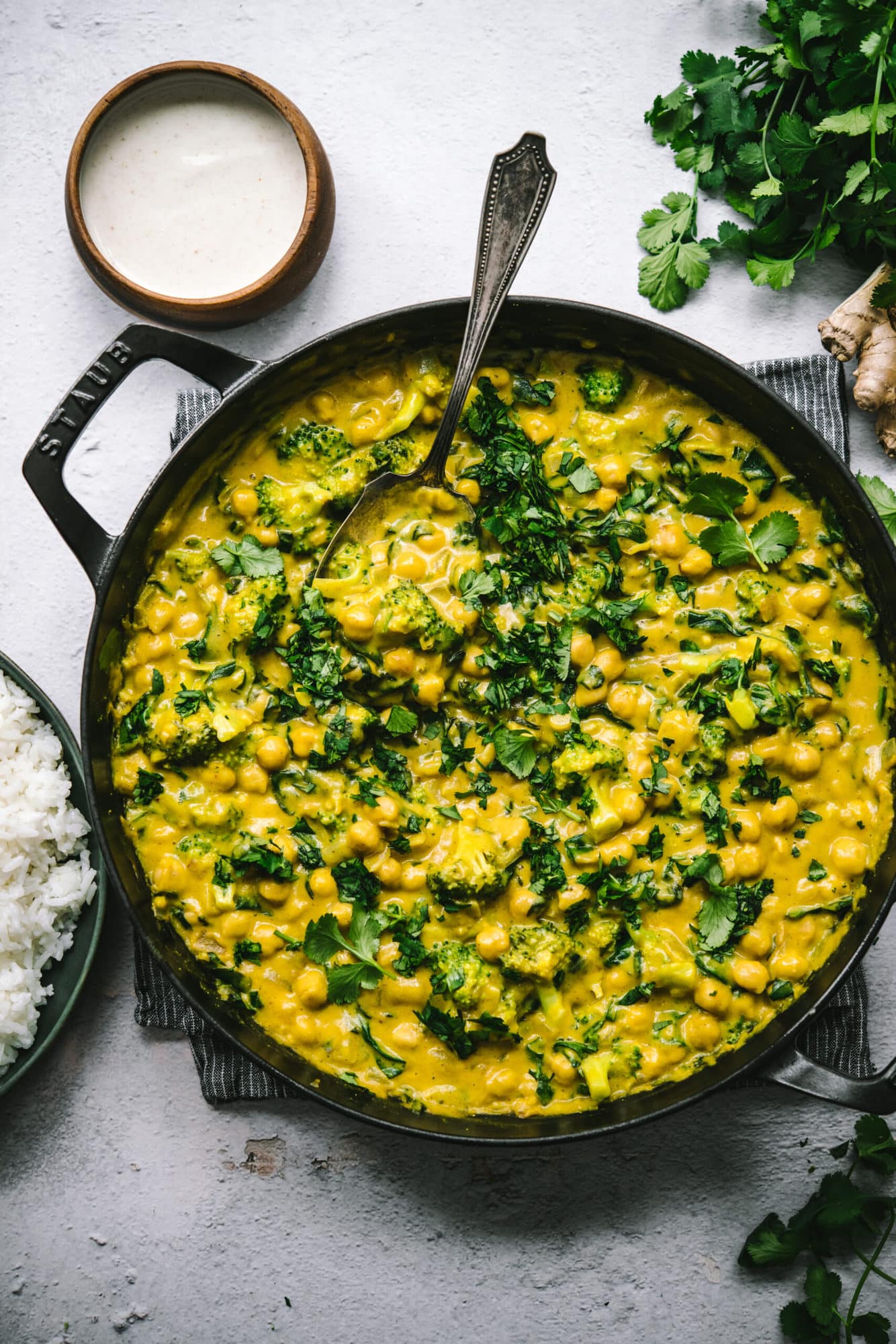 overhead view of vegan mango chickpea curry in a large skillet. 