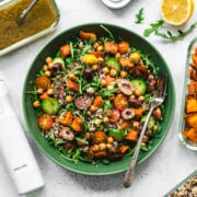 overhead view of quinoa arugula and sweet potato salad in a green bowl.