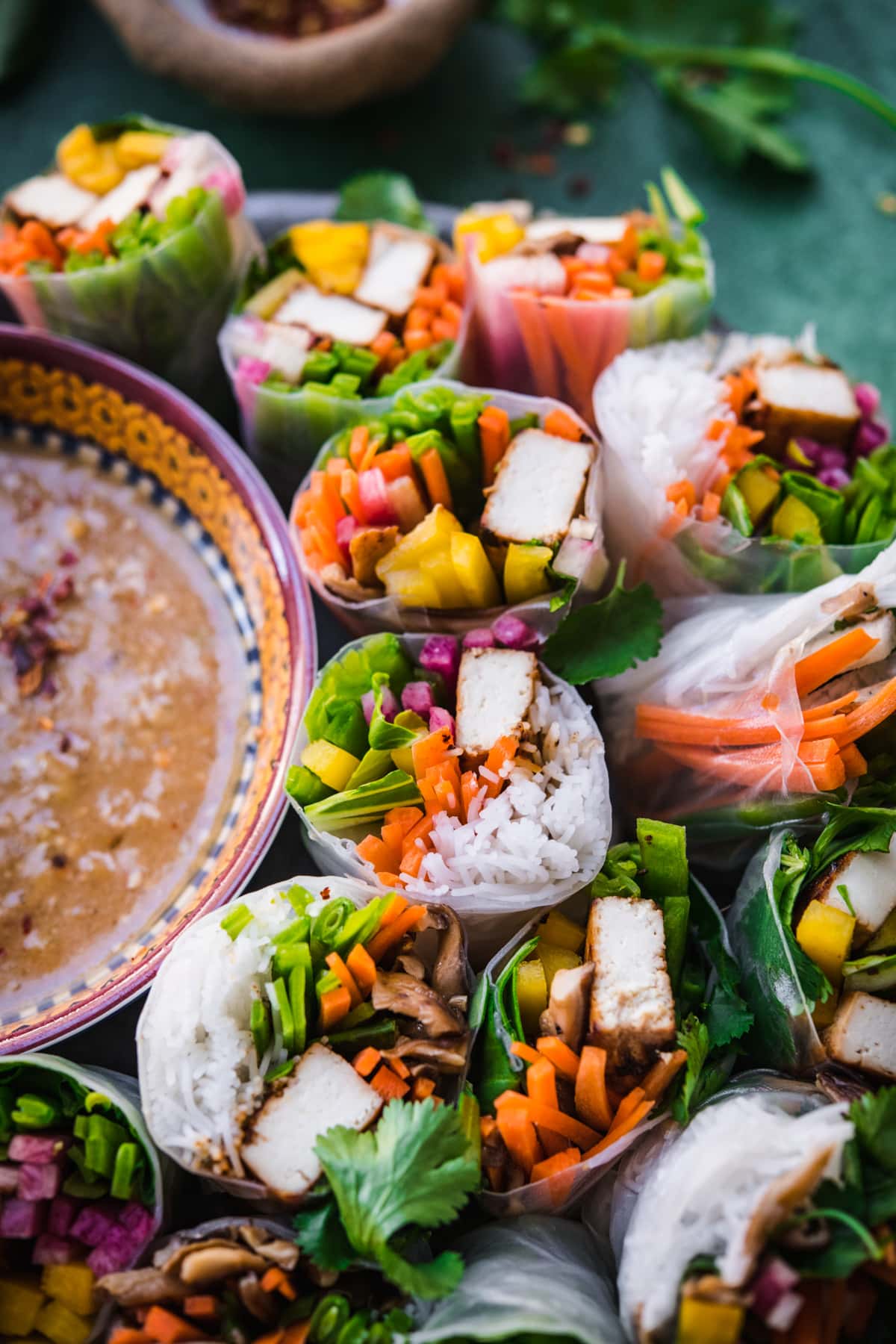 close view of tofu vegetable summer rolls on a circular platter.